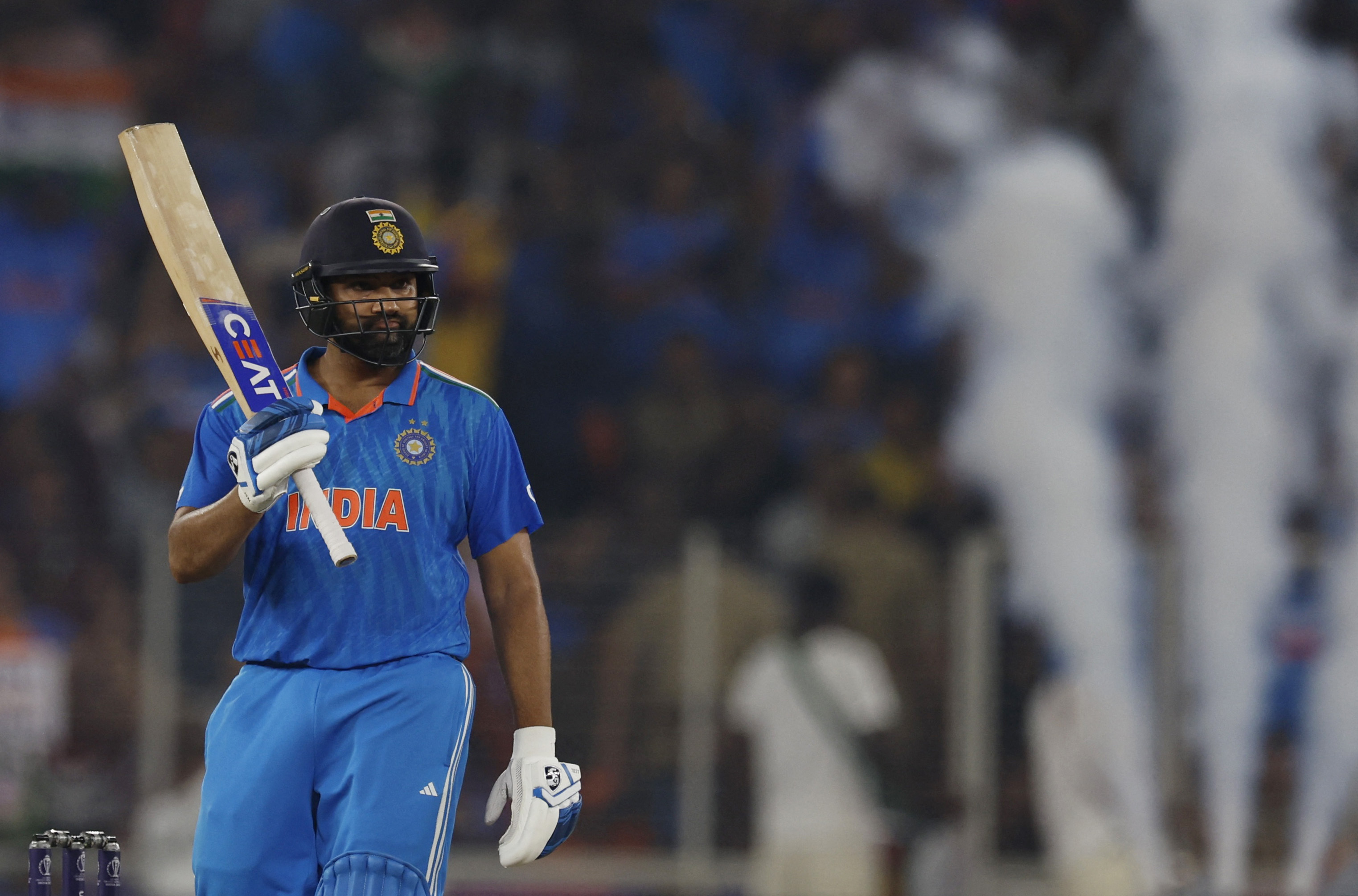 Rohit Sharma celebrates after reaching his half century
