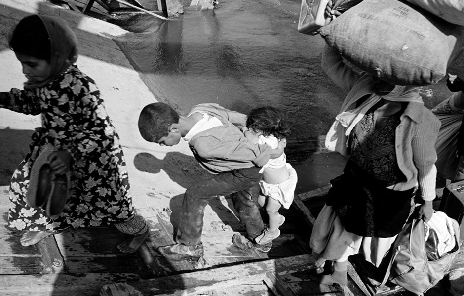 Palestinian refugees flee across the Allenby Bridge over the Jordan River, 1967. The bridge connects the West Bank with Jordan.