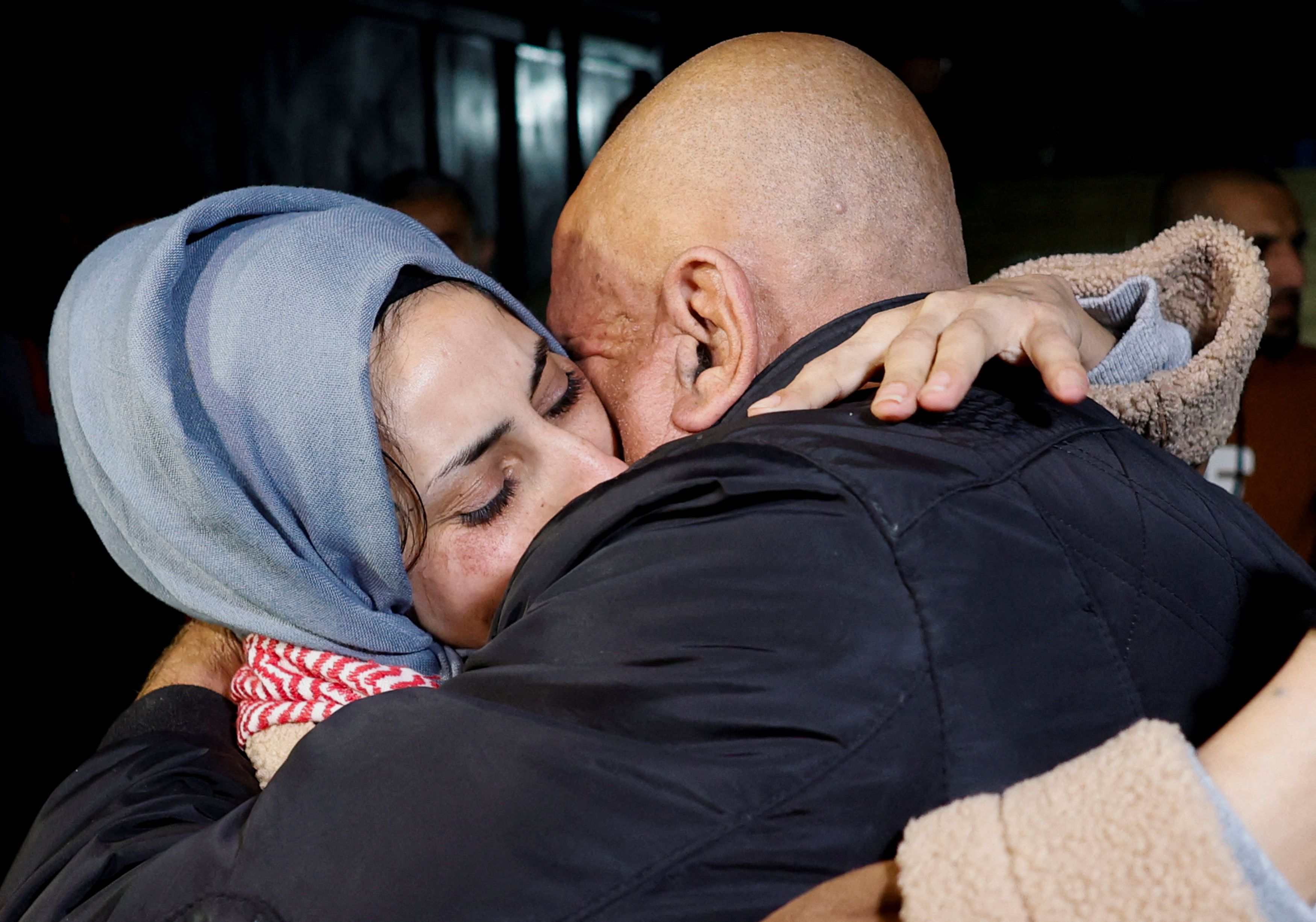 Released Palestinian prisoner Lamees Abu Arkoob is embraced by her father outside her house near Hebron in the Israeli-occupied West Bank, amid a hostages-prisoners swap deal between Hamas and Israel, November 29, 2023. 