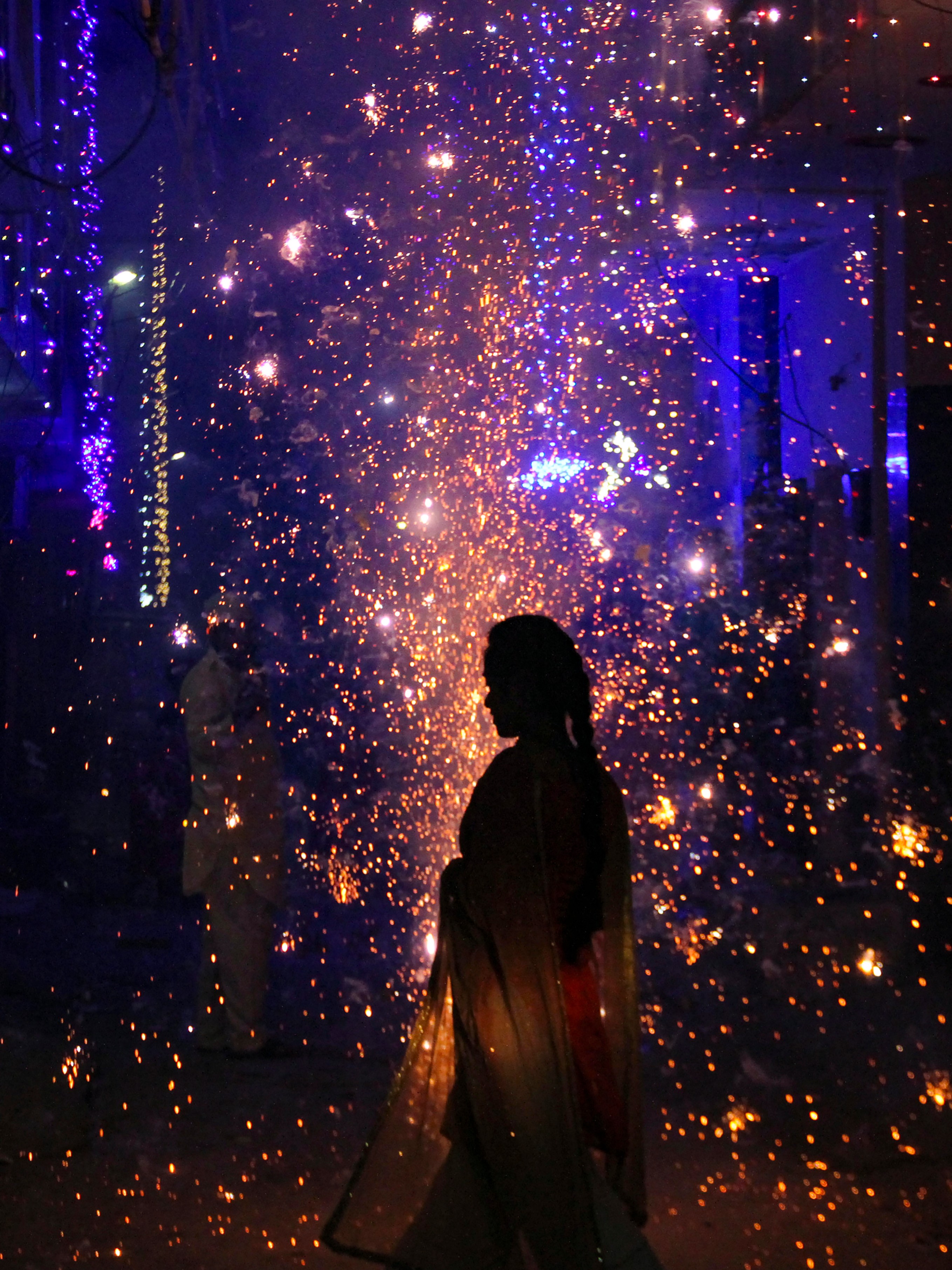 People burst firecrackers as they celebrate Diwali, in Gurugram.