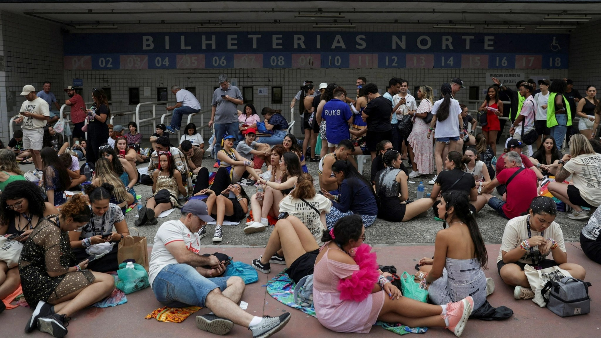 Fans wait outside Nilton Santos stadium for the Taylor Swift concert, following the death of a fan due to the heat during the first day concert, in Rio de Janeiro, Brazil, November 20, 2023. 