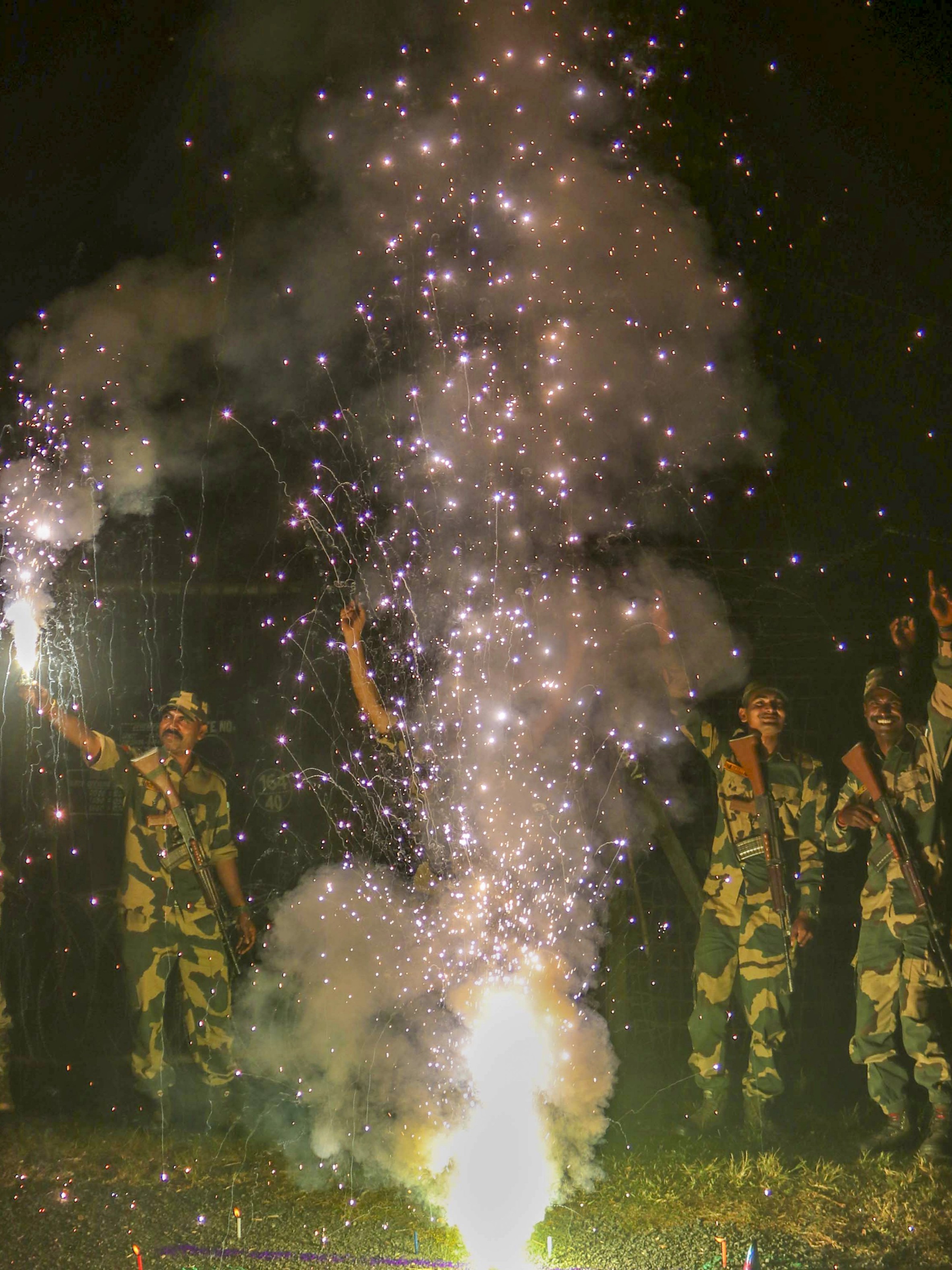 Border Security Force (BSF) personnel burn sparkles during Diwali celebrations at the India-Bangladesh Border near Balurghat, in West Bengal.
