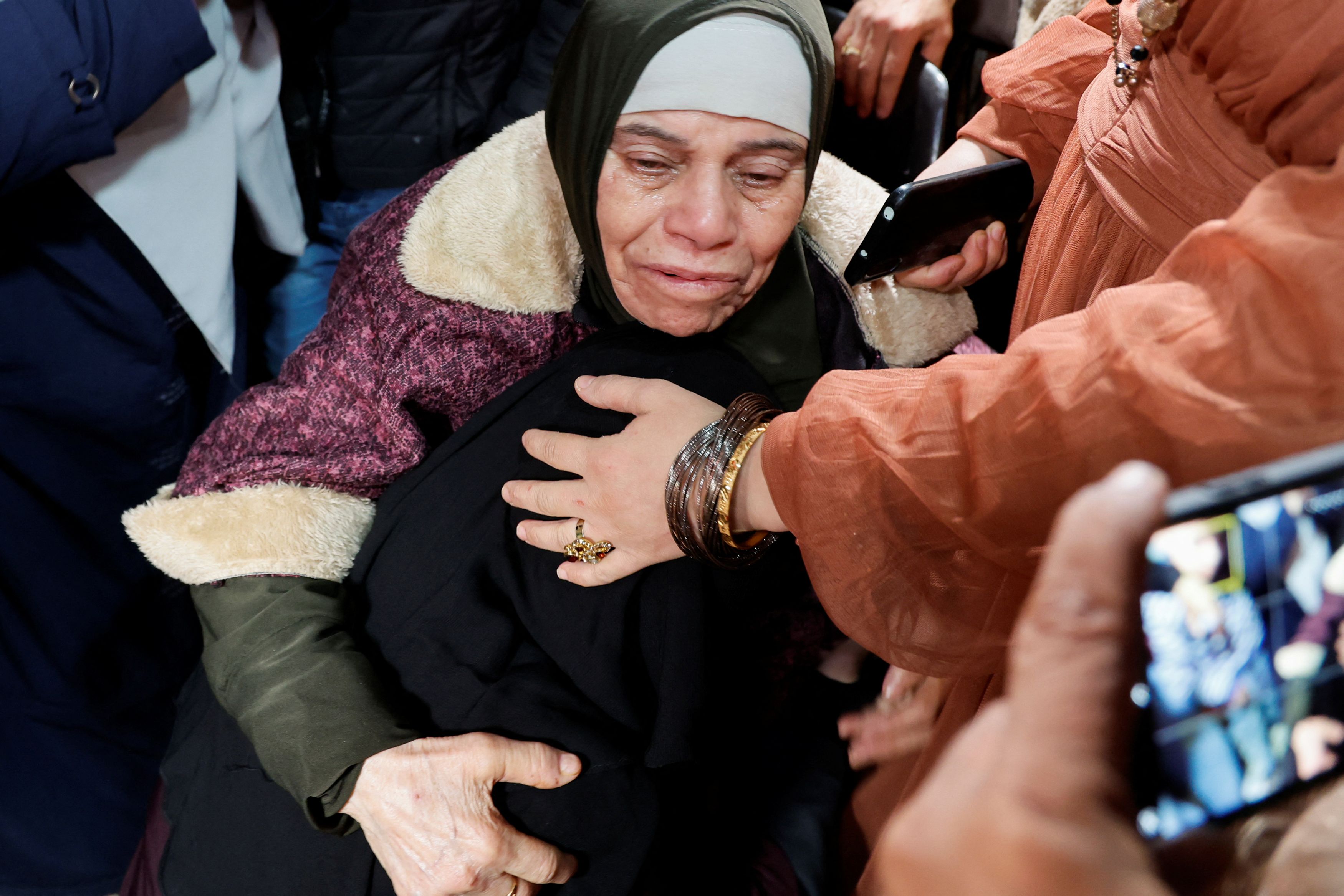 Family members react as they welcome released Palestinian prisoner Fatima Amarneh, amid a hostages-prisoners swap deal between Hamas and Israel, near Jenin in the Israeli-occupied West Bank November 25, 2023.