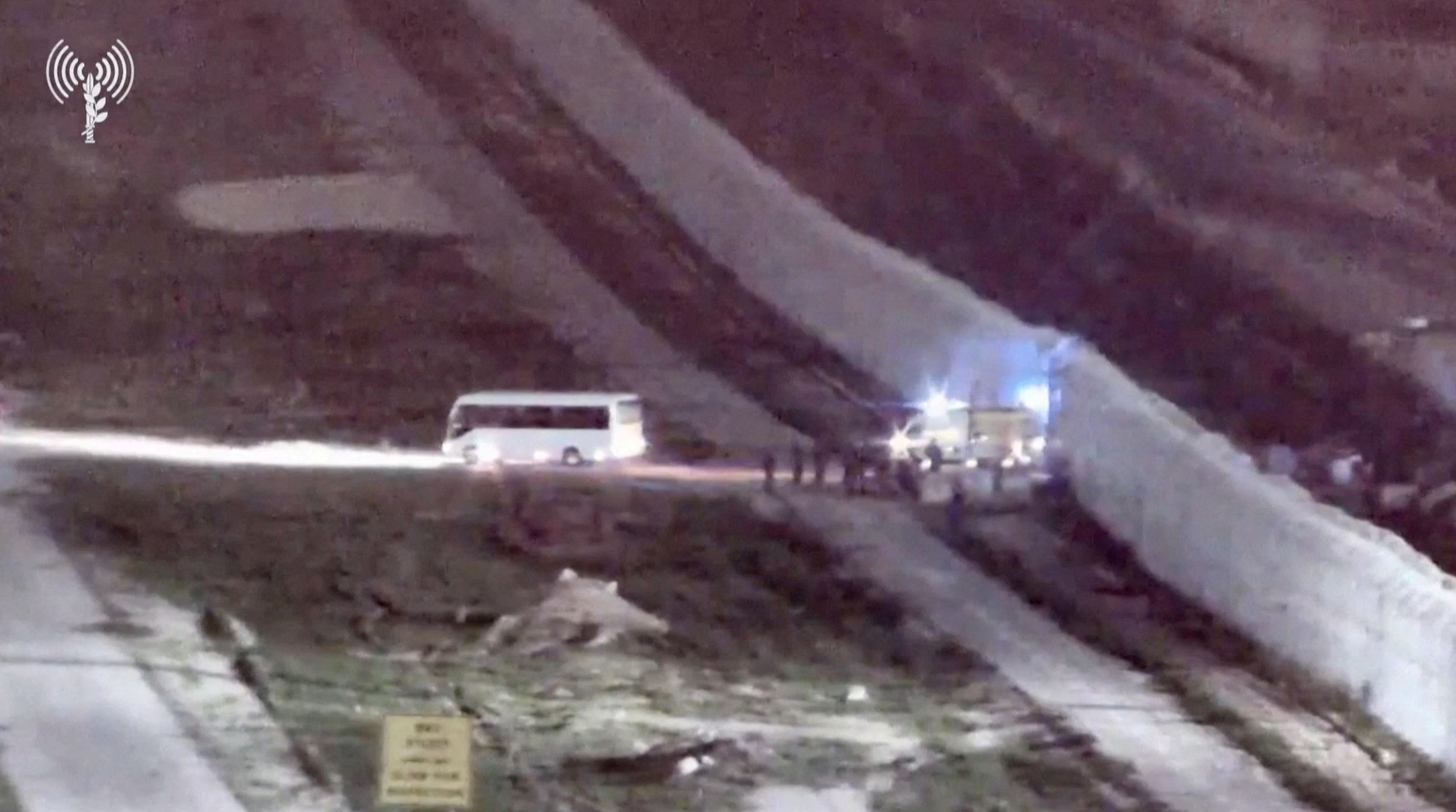 A bus and an ambulance cross from Egypt's Rafah crossing toward Israel, amid a hostages-prisoners swap deal between Hamas and Israel, in this screengrab taken from video released on November 25, 2023.  via REUTERS THIS IMAGE HAS BEEN SUPPLIED BY A THIRD PARTY.