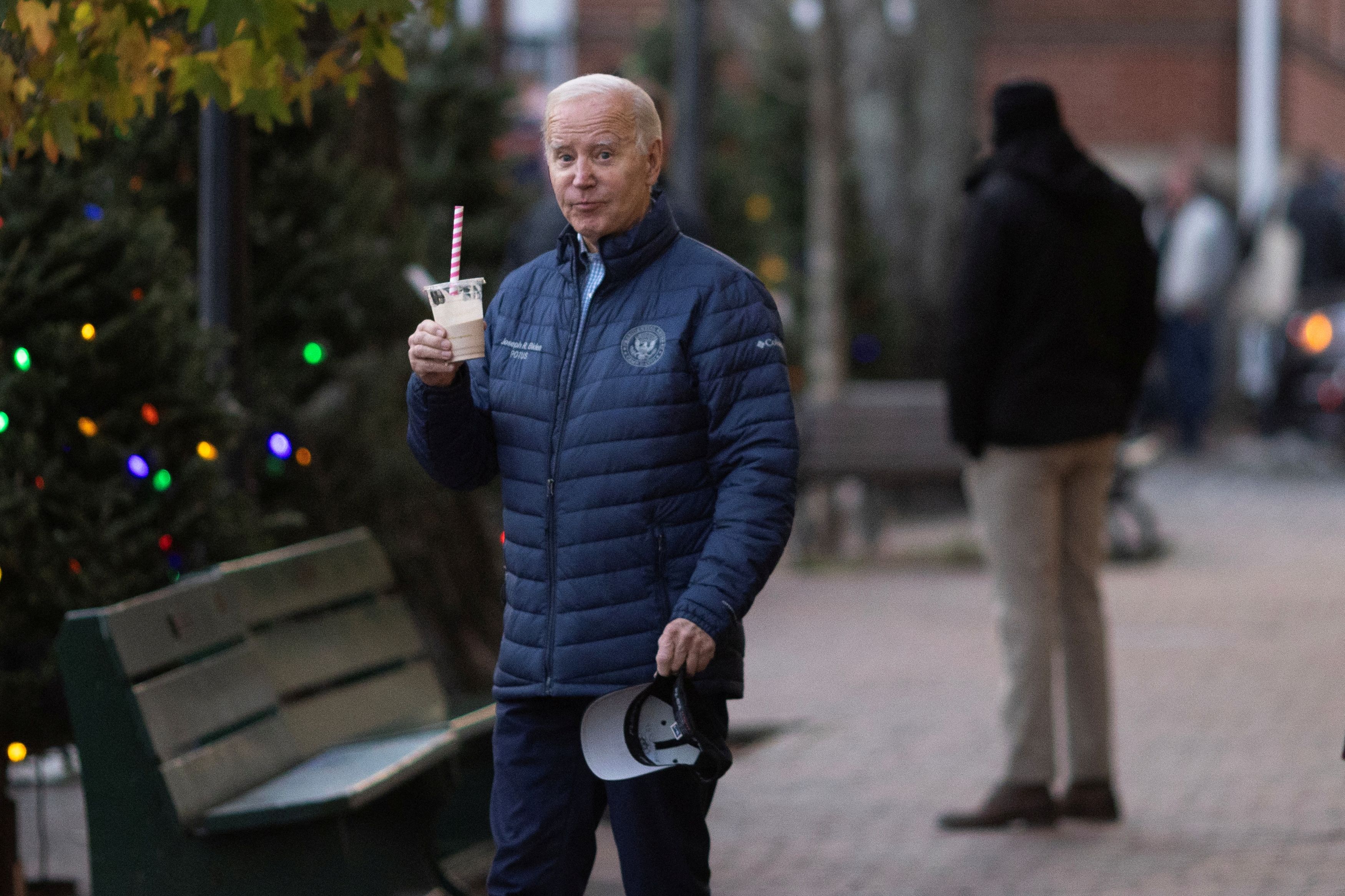 U.S. President Joe Biden holds a beverage while shopping with family members in Nantucket, Massachusetts, U.S., November 25, 2023.