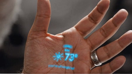 It contains a small projector that can beam text and laser icons onto the user's palm in place of a screen.