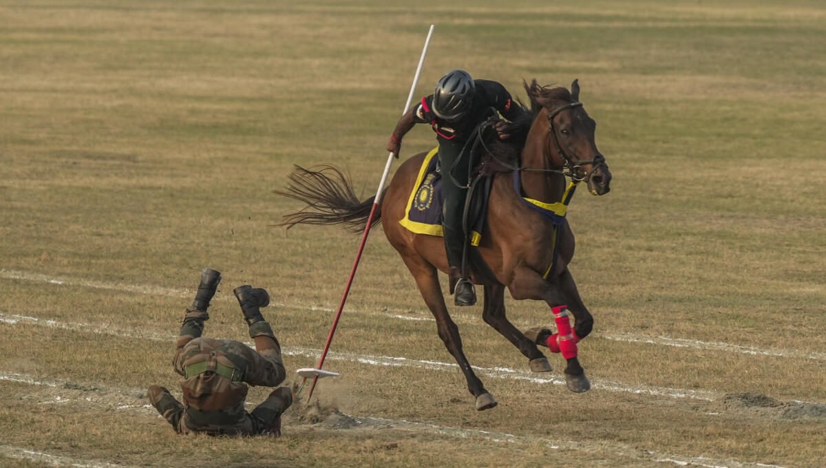 Indian Army personnel perform 'tent pegging' during 'Military Tattoo' show to celebrate 'Vijay Diwas', in Kolkata.