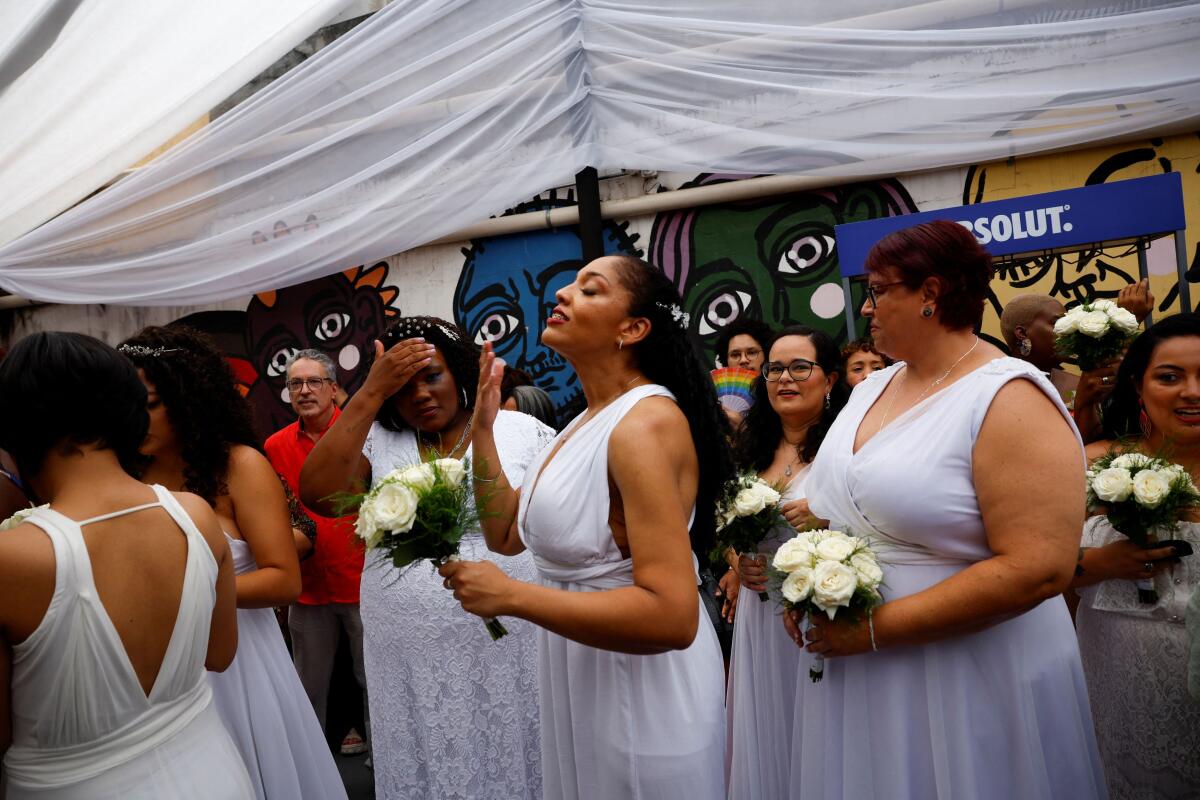 Brides line up during the collective wedding ceremony for 9 same-sex couples organized by "House 1", an NGO and residential shelter in Sao Paulo, Brazil. 