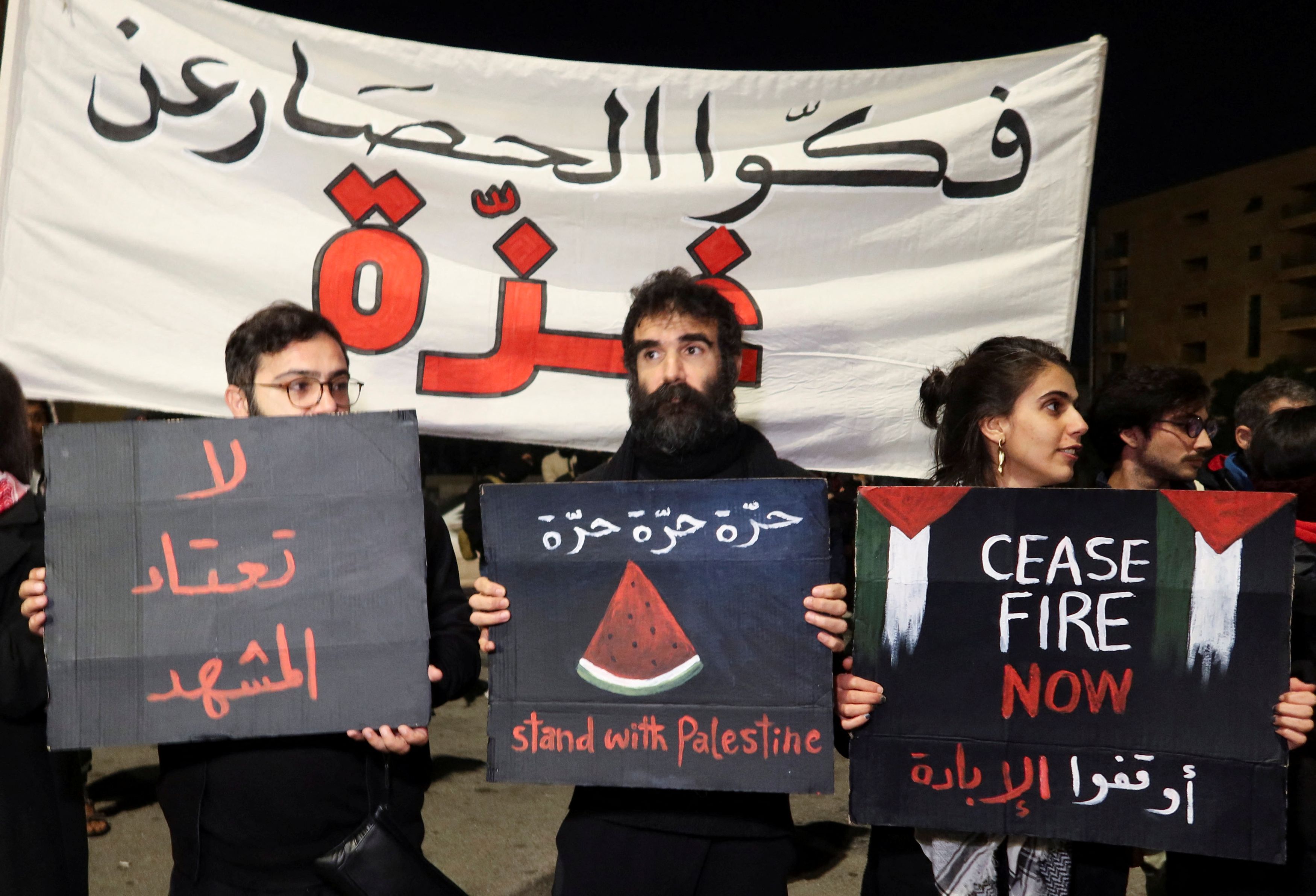 Demonstrators hold signs during a protest demanding permanent ceasefire in Gaza, amid the ongoing conflict between Israel and the Palestinian Islamist group Hamas, on New Year's Eve in Beirut, Lebanon December 31, 2023. REUTERS/Jihed Abidellaoui