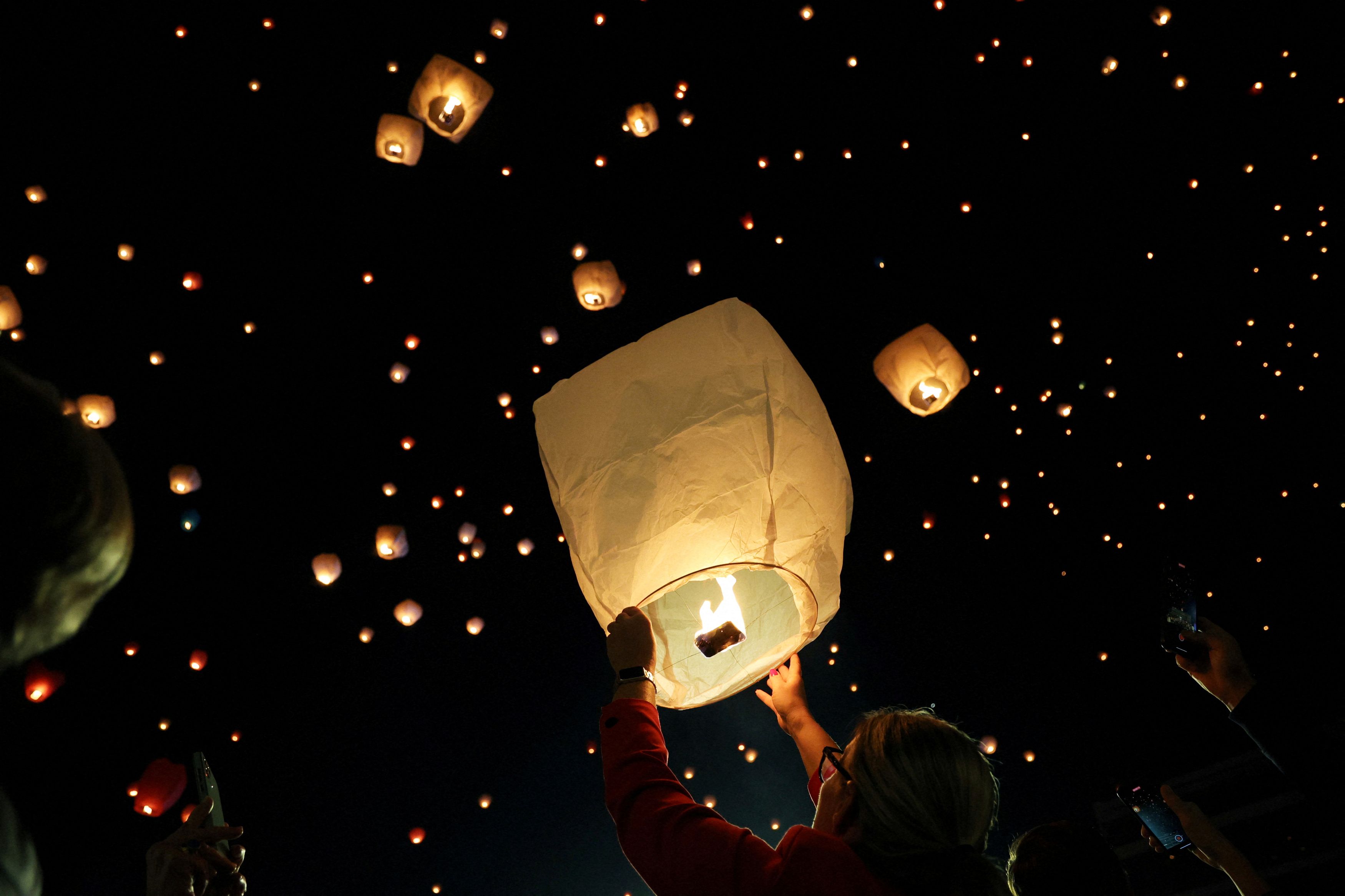 A person releases a sky lantern during Christmas festivities, in Athens, Greece, December 24, 2023.