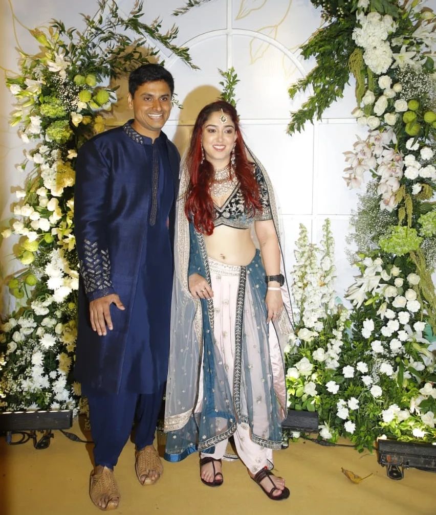 Nupur Shikhare  and Ira Khan pose for photographers as they arrive at their reception ceremony in Mumbai.