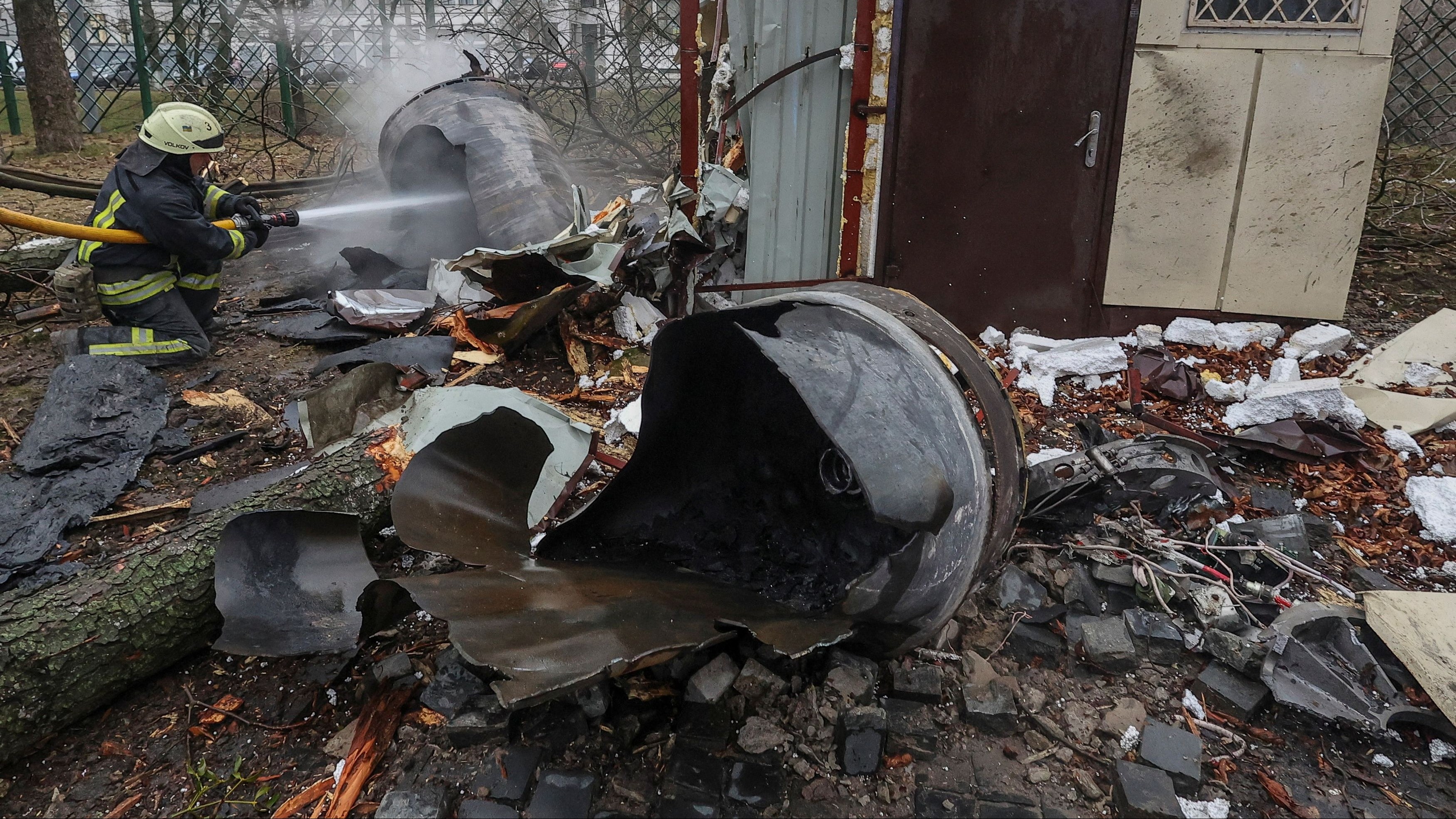 A firefighter extinguishes remains of an unidentified missile, which Ukrainian authorities claimed to be made in North Korea, at a site of a Russian strike, amid Russia's attack on Ukraine, in Kharkiv, Ukraine January 2, 2024.