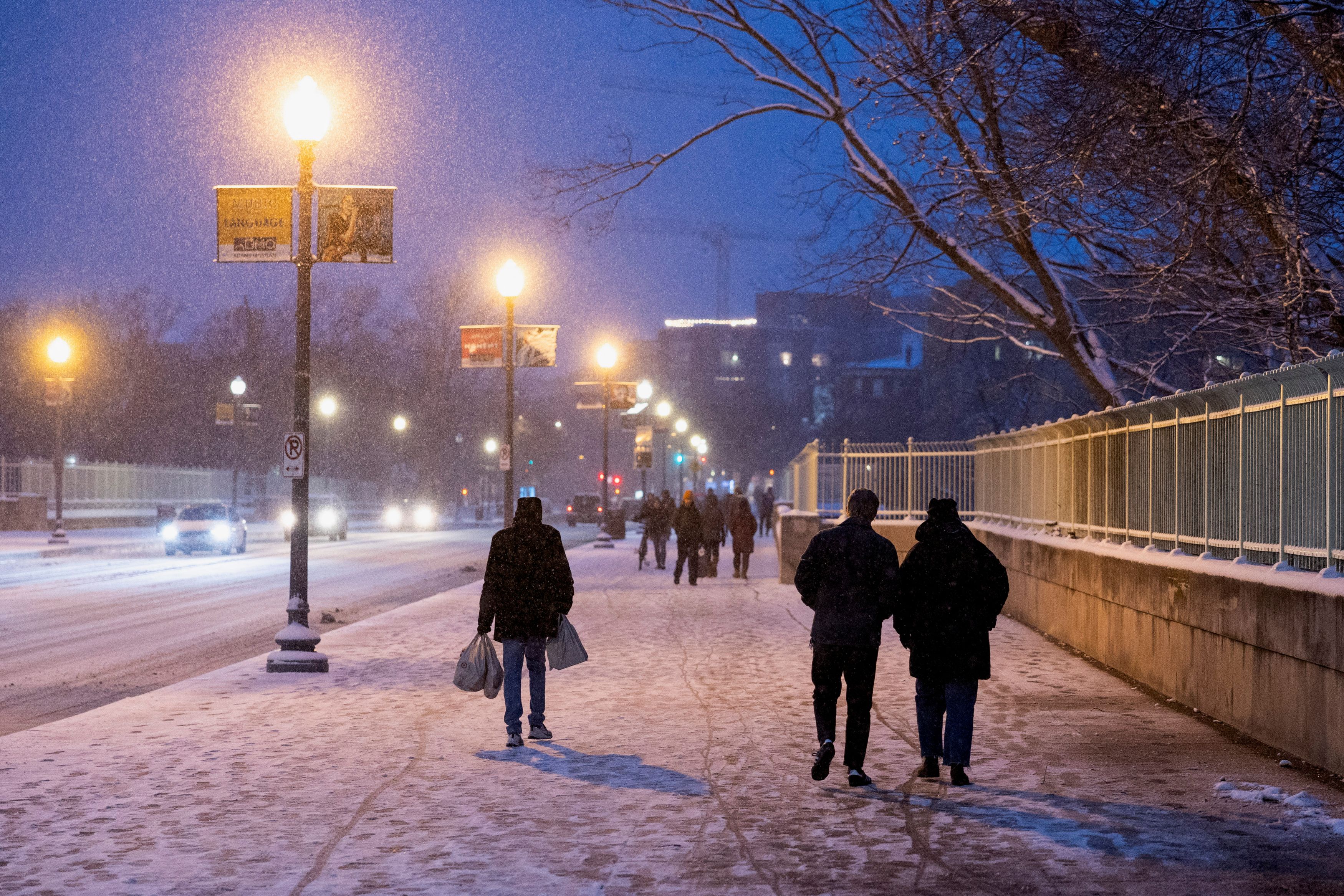 People walk through the snow on the Duke Ellington Memorial Bridge in Washington.