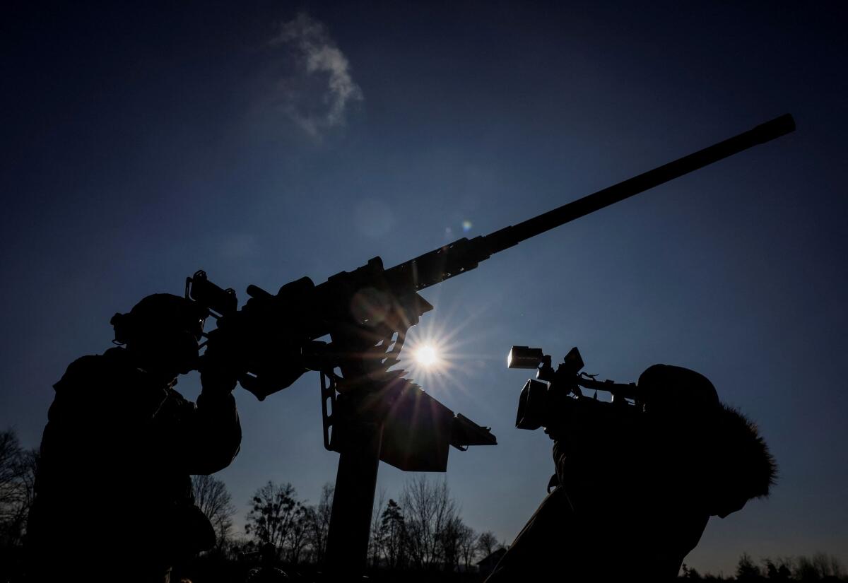 A cameraman films a Ukrainian serviceman from an air defence unit, amid Russia's attack on Ukraine, near Kyiv, Ukraine January 29, 2024. 