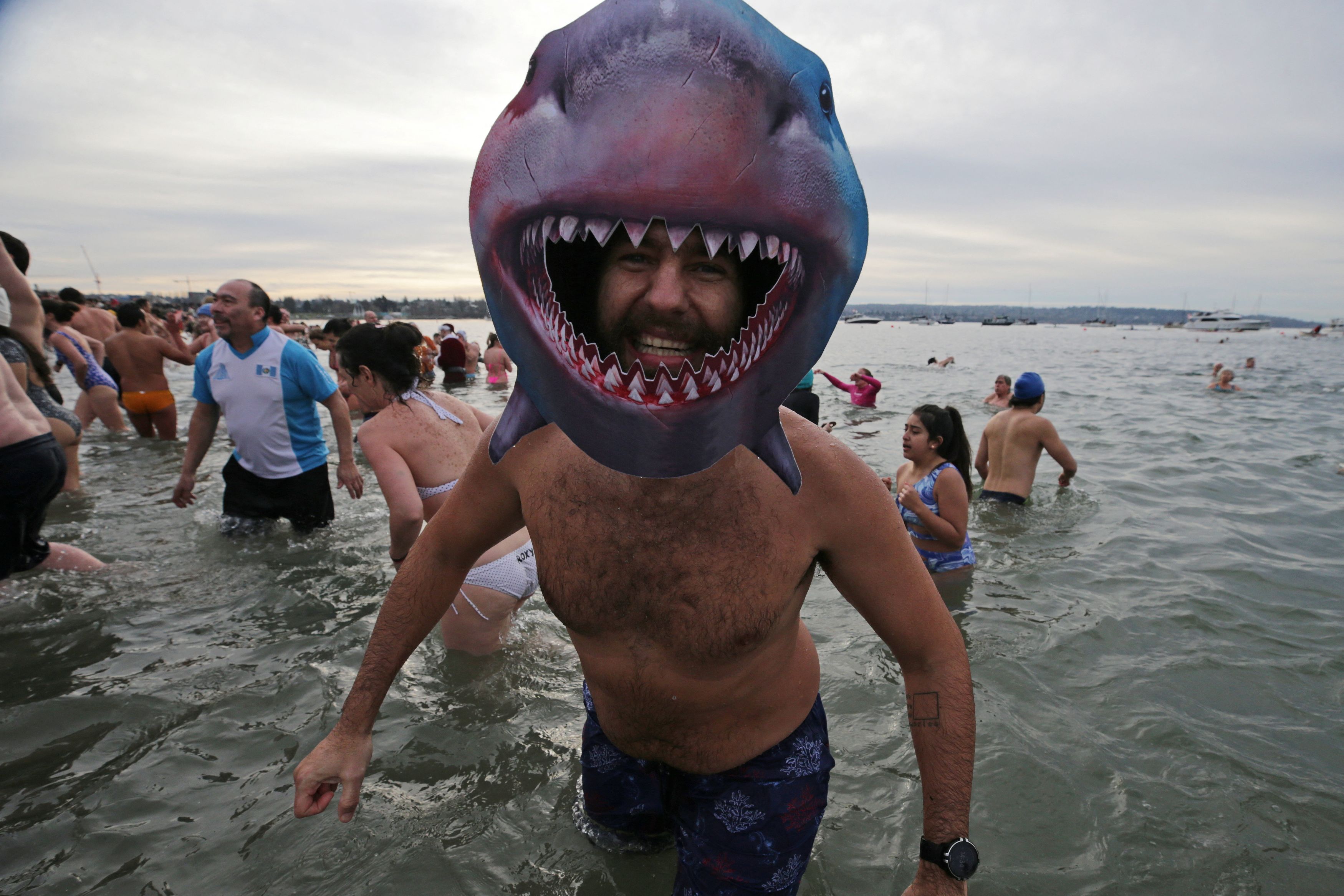 A bather exits the chilly waters of English Bay while celebrating New Year's Day with the Polar Bear Swim in Vancouver, British Columbia, Canada, January 1, 2024.  