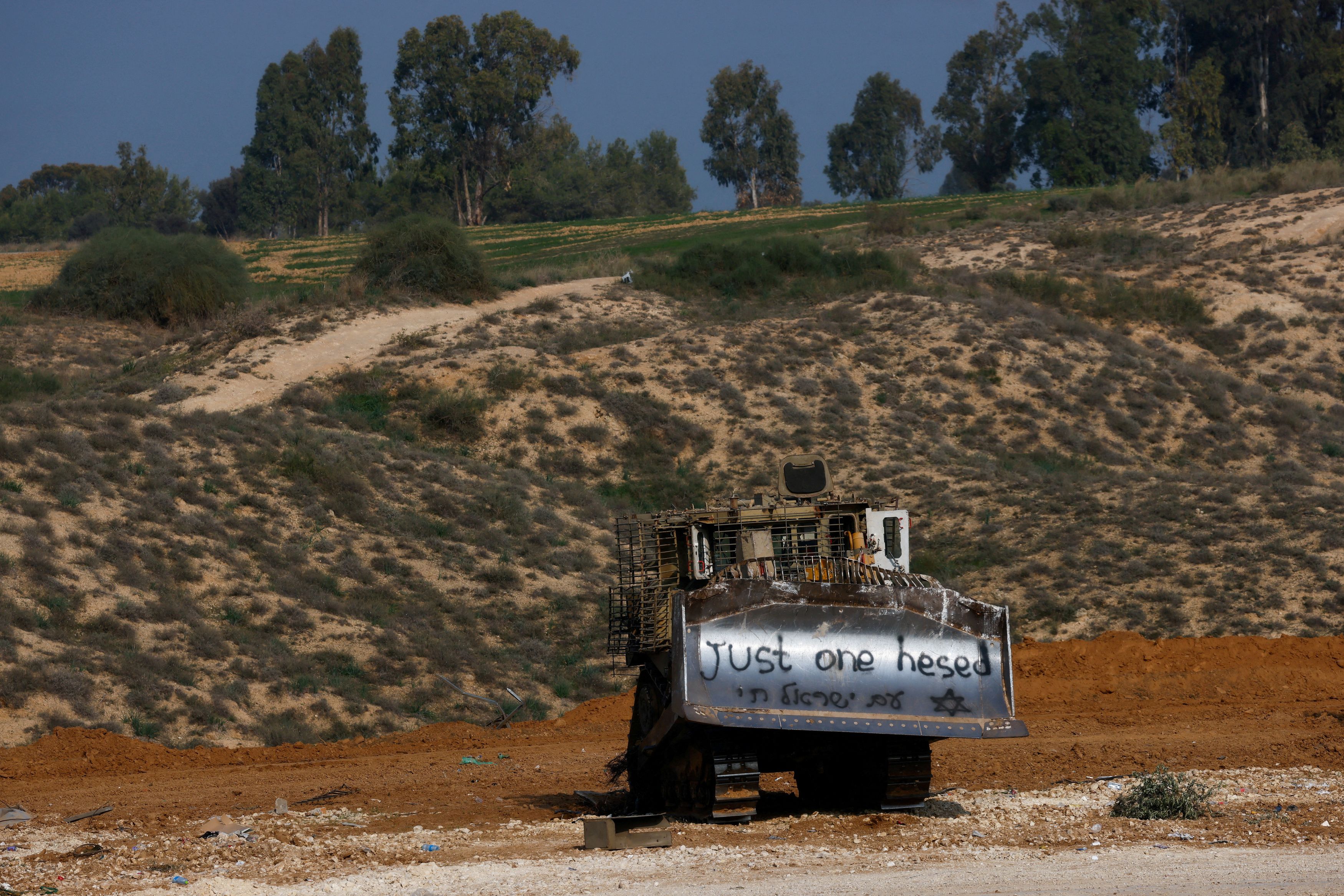 An Israeli bulldozer is seen outside the border with central Gaza, amid the ongoing conflict between Israel and the Palestinian Islamist group Hamas, in southern Israel, January 1, 2024.