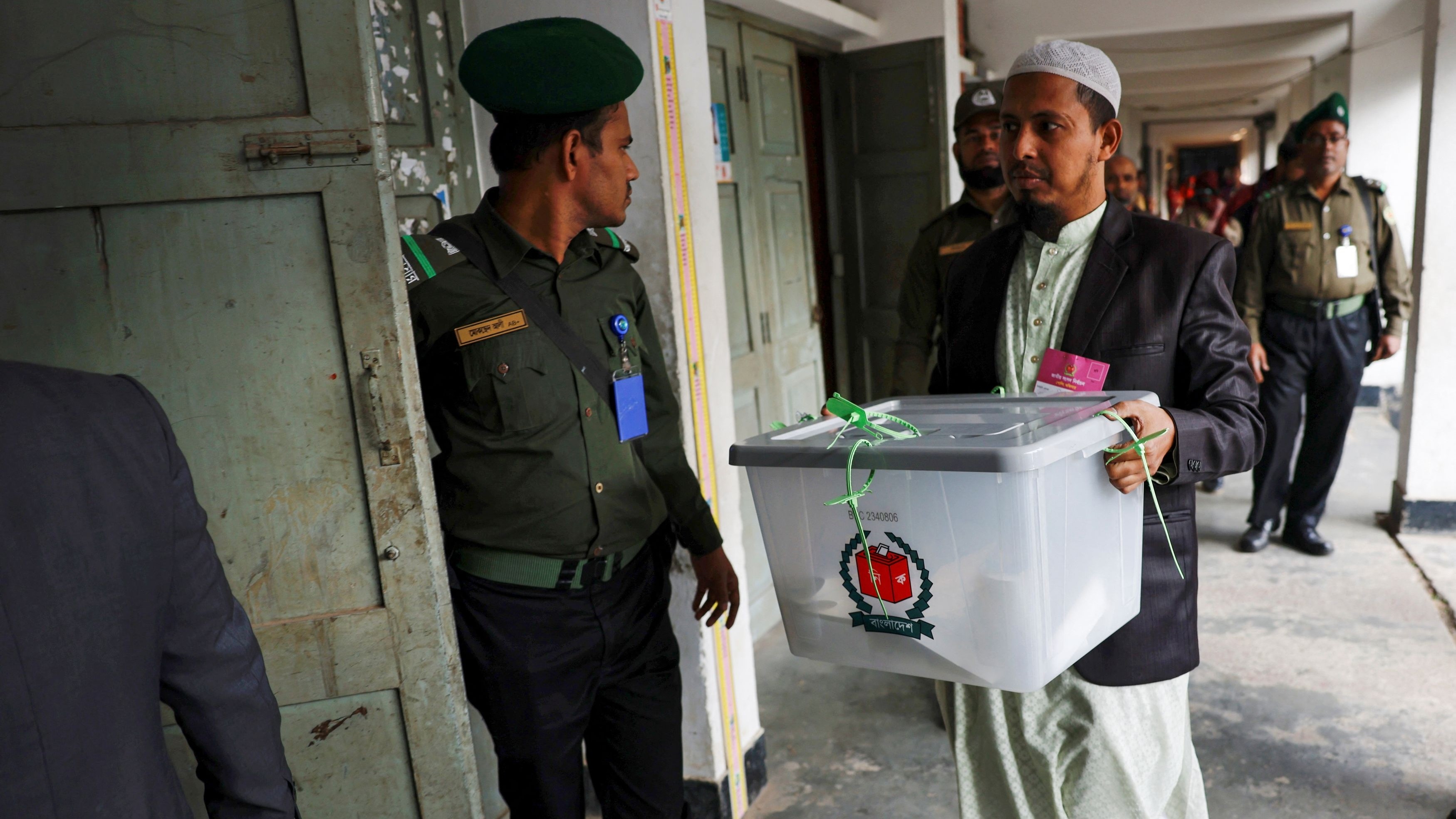 An official brings ballot box for counting casted votes after voting is timed out at a polling station, during the 12th general election in Dhaka, Bangladesh, January 7, 2024.