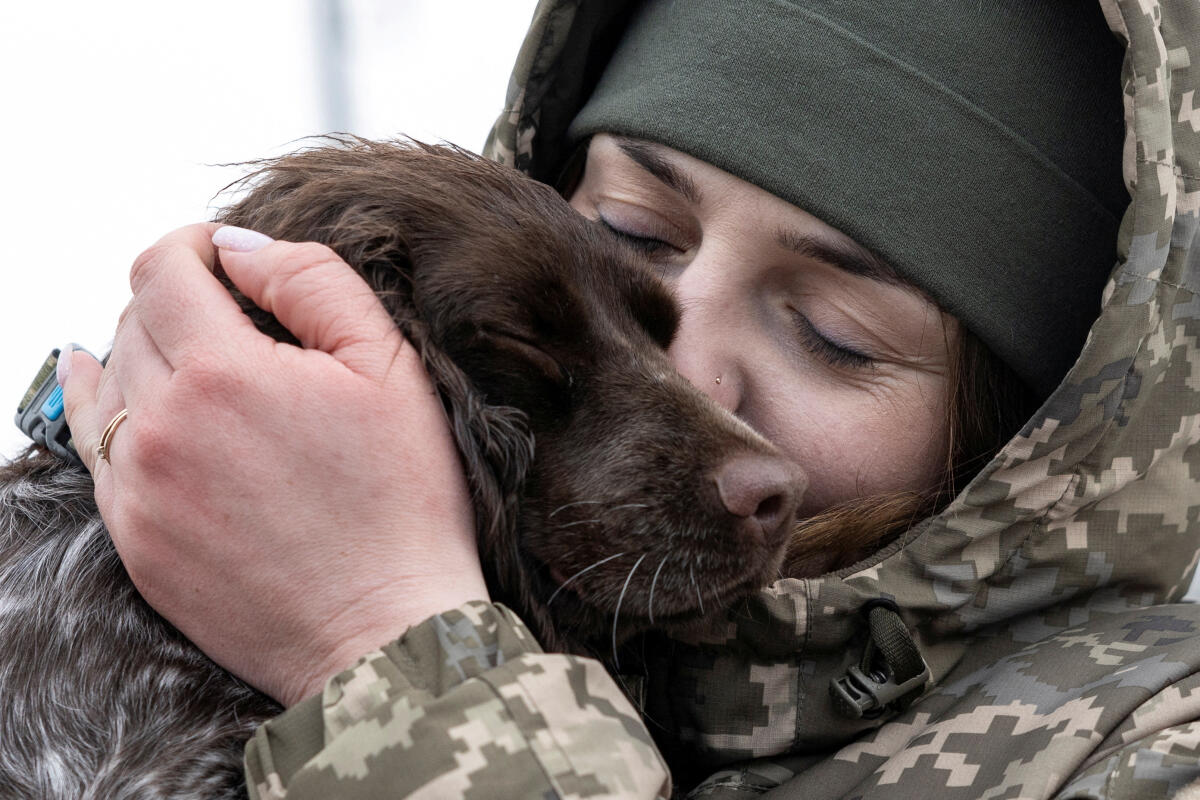 Alina Panina, 27-year-old, Ukrainian border guard member and former prisoner of war (POW), embraces her service dog 'Roksi', amid Russia's attack on Ukraine, in the town of Novovolynsk, Volyn region, Ukraine January 23, 2024.
