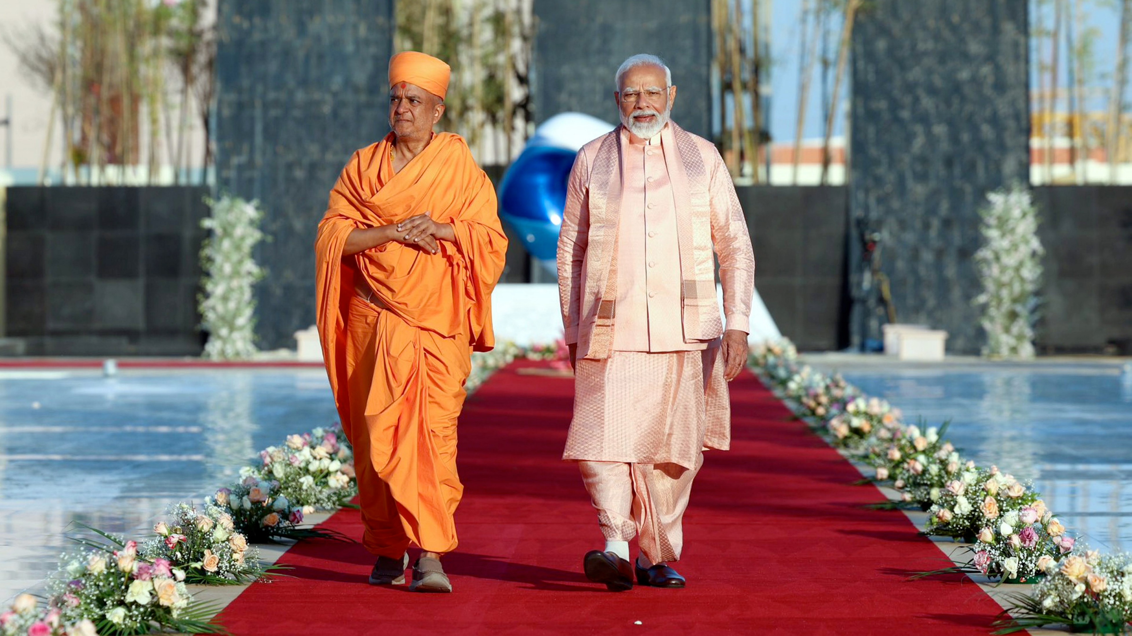 Dressed in a light pink silk dhoti and kurta paired with a sleeveless jacket and stole, Modi took a tour of the temple spread across a 27-acre campus.