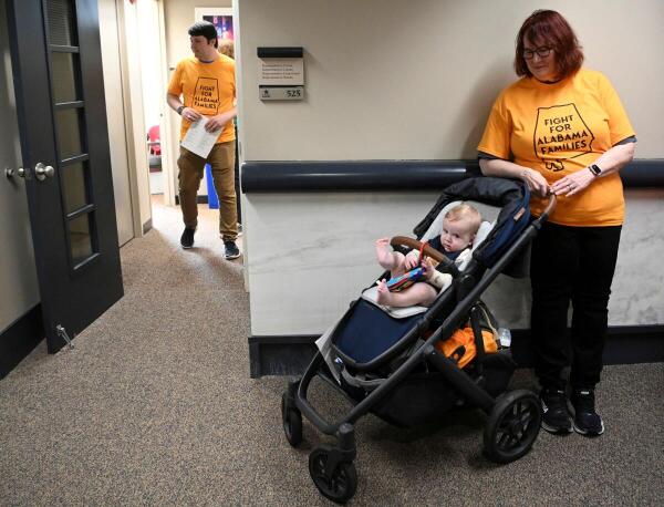 Grandma Audrey O'Neil, watches over 7-month-old Mason Deleeuw as his parents Peter and Meredith Deleeuw of Huntsville, lobby lawmakers for support of legislation safeguarding in vitro fertilization (IVF) treatments at the Alabama State House in Montgomery, Alabama, U.S. February 28, 2024. Mason, was conceived after five rounds of IVF treatments for the Deleeuwes.