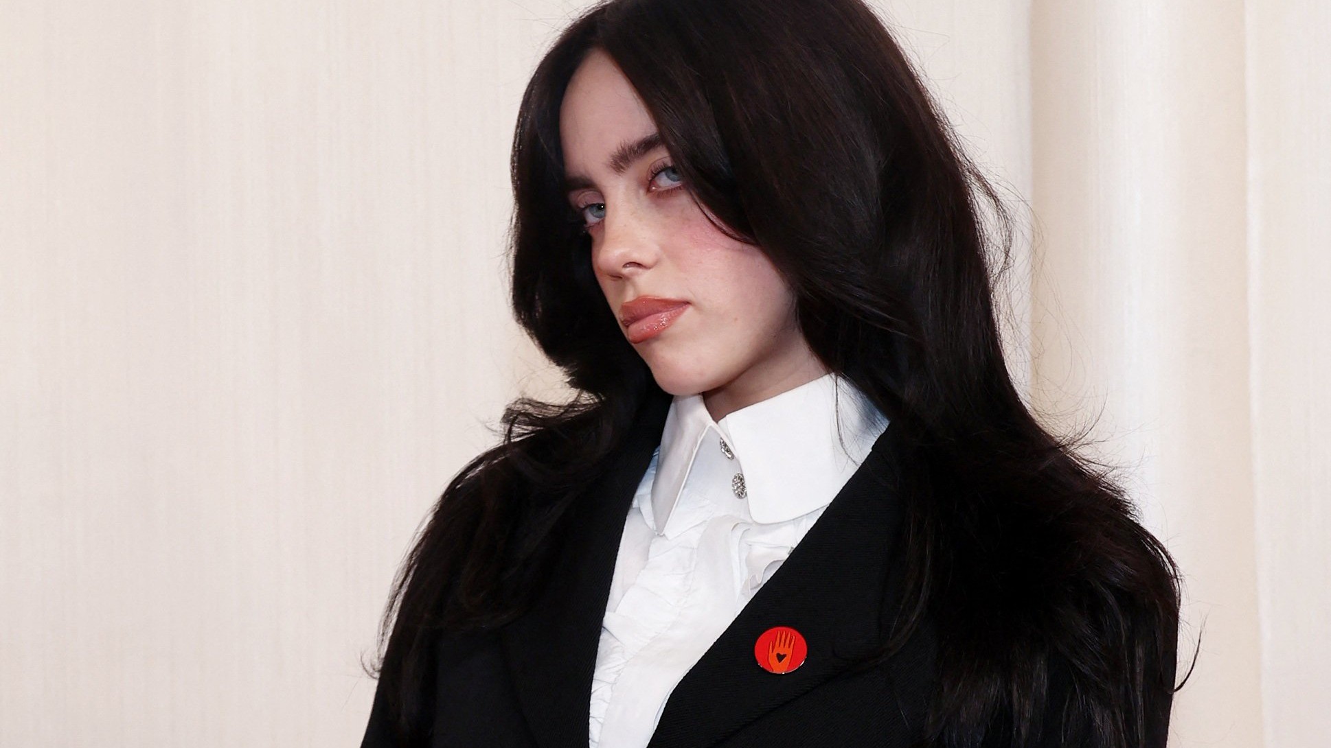 Billie Eilish gets clicked arriving at the Oscar 2024 red carpet donning the red pin.