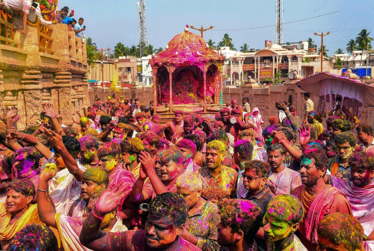 Devotees celebrate Holi at the Jagannath temple in Puri.