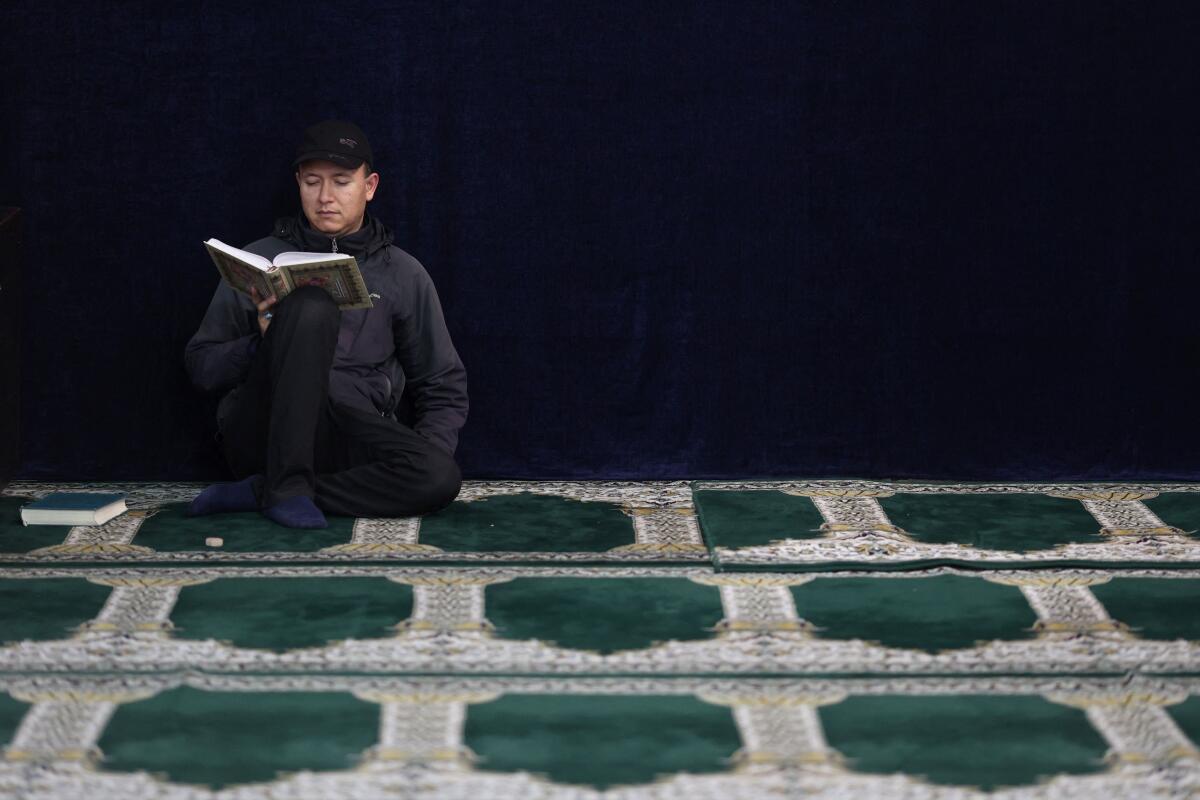 An Iranian man reads the Koran in the shrine of Abdol-Azim, during the holy month of Ramadan in Tehran, Iran. 