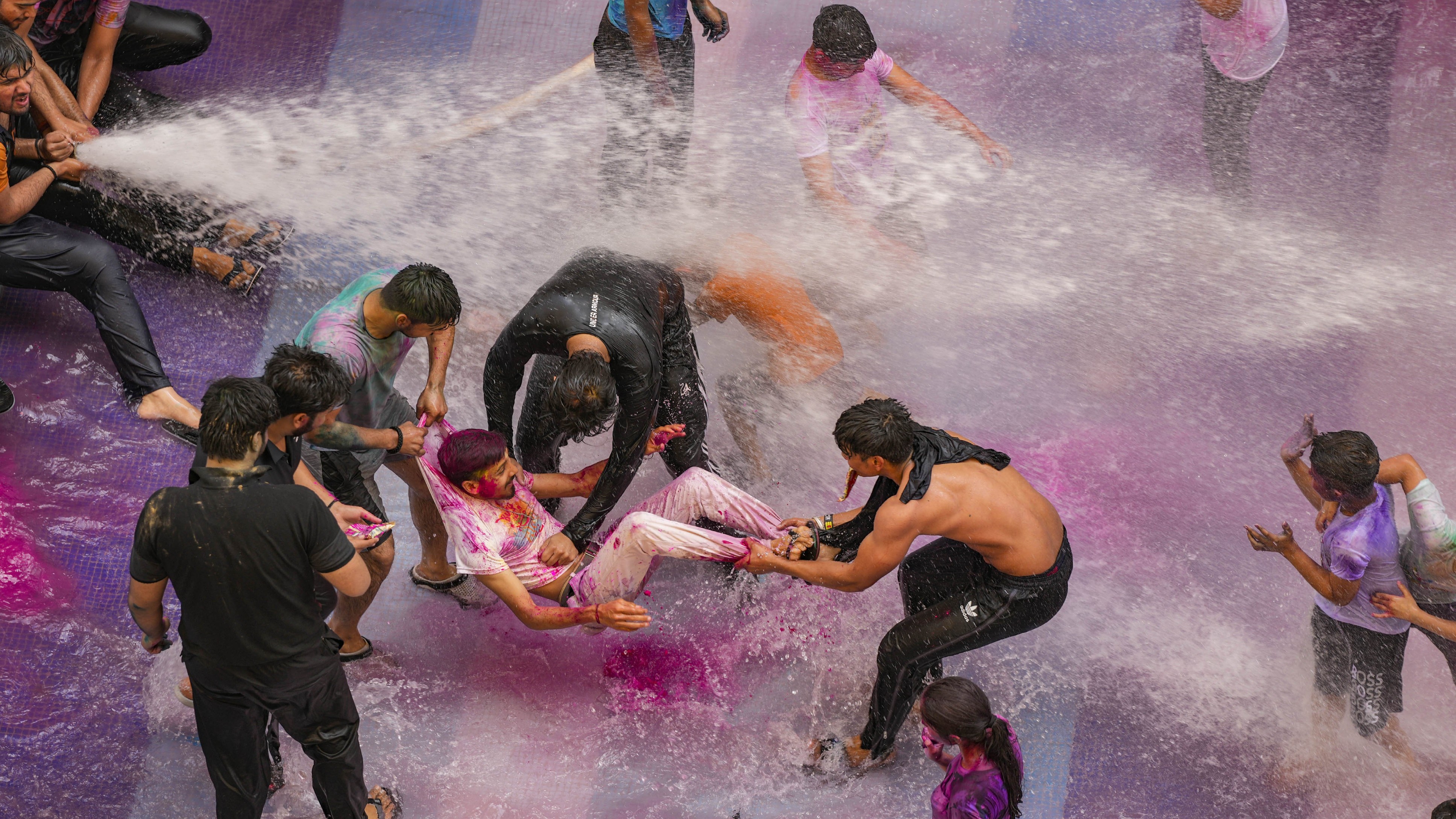 People during Holi festival celebrations at a society, in Gautam Buddha Nagar, Noida