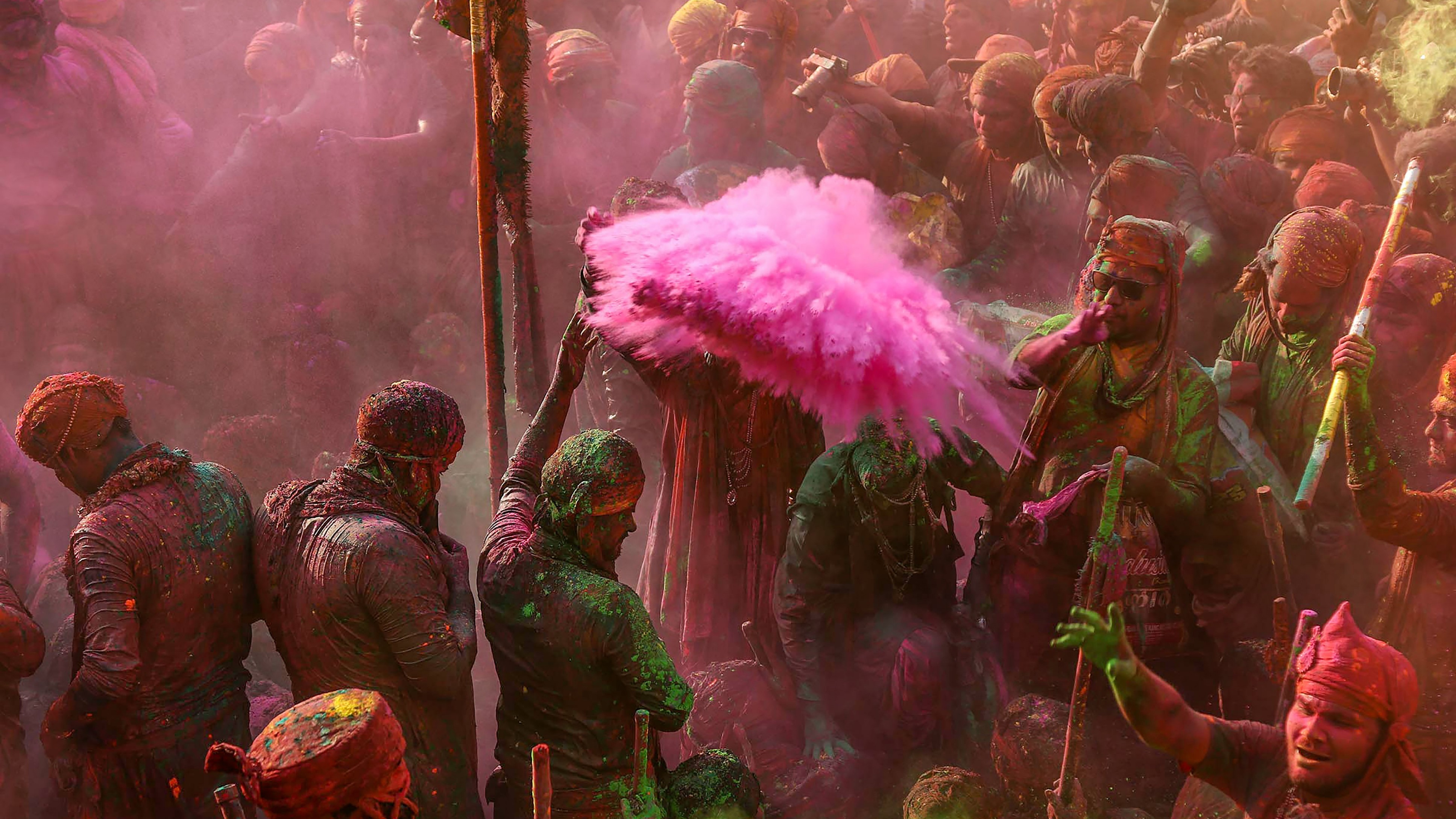 People apply colours on each other during the Lathmar Holi celebrations at Nandgaon, in Mathura.