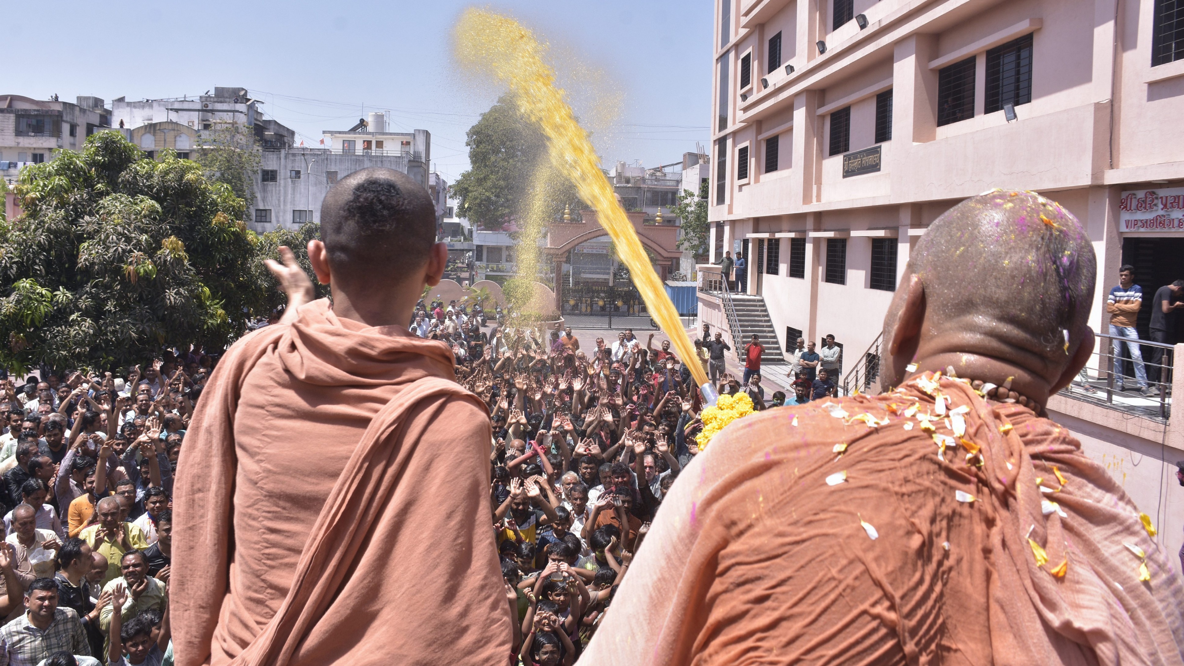 Saints spray coloured water during Holi celebrations, in Surat.