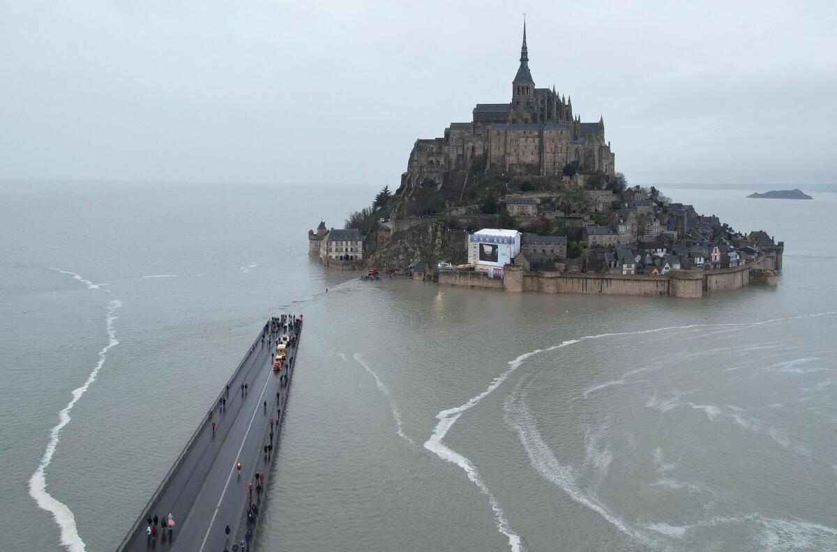 A drone view shows Mont Saint-Michel surrounded by sea during a high tide, in the French western region of Normandy, France, March 12, 2024.