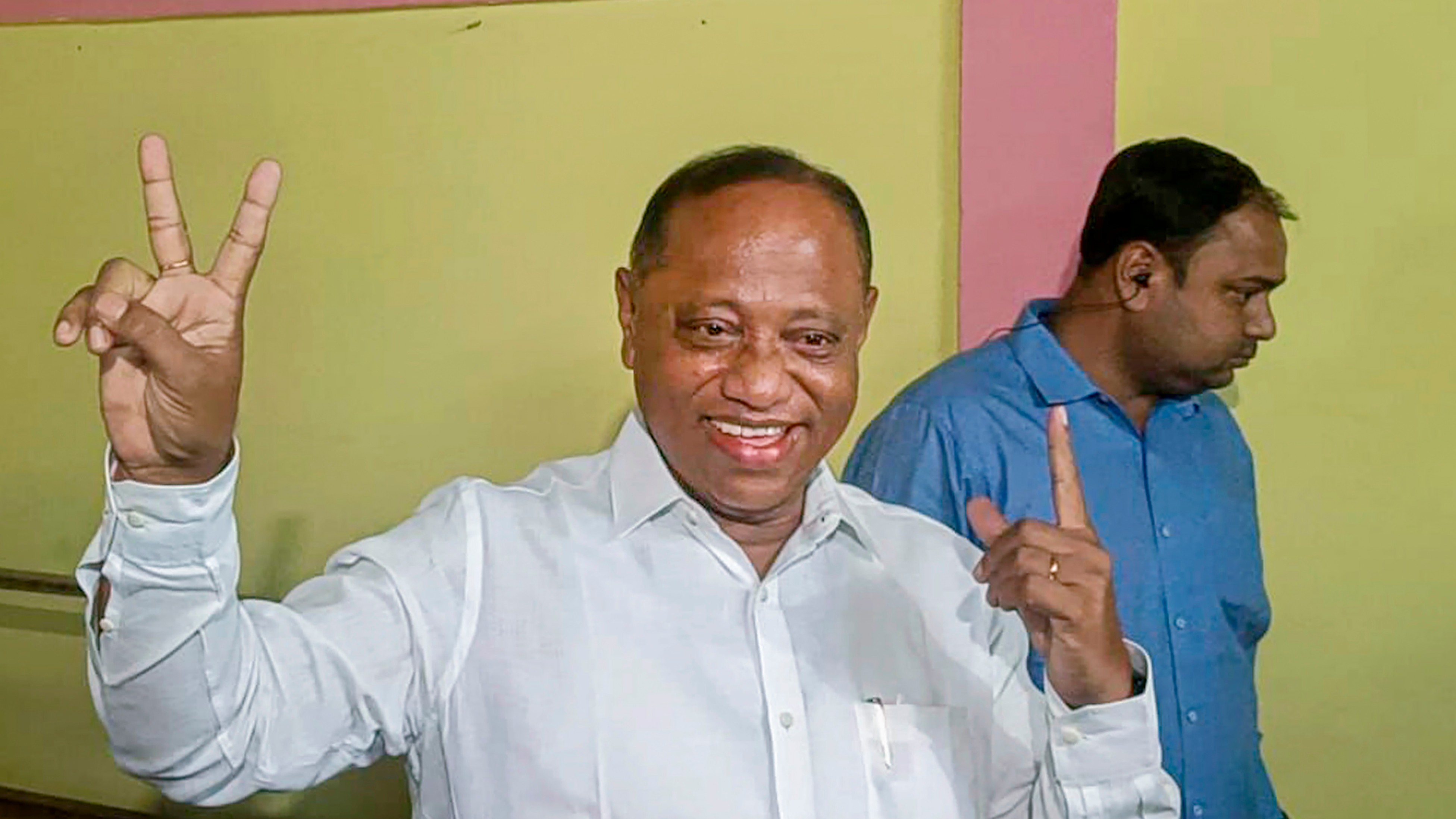 Bharatiya Janata Party (BJP) candidate from Silchar Parimal Suklabaidya shows his ink-marked finger after casting his vote in the second phase of Lok Sabha elections, in Silchar, Assam.