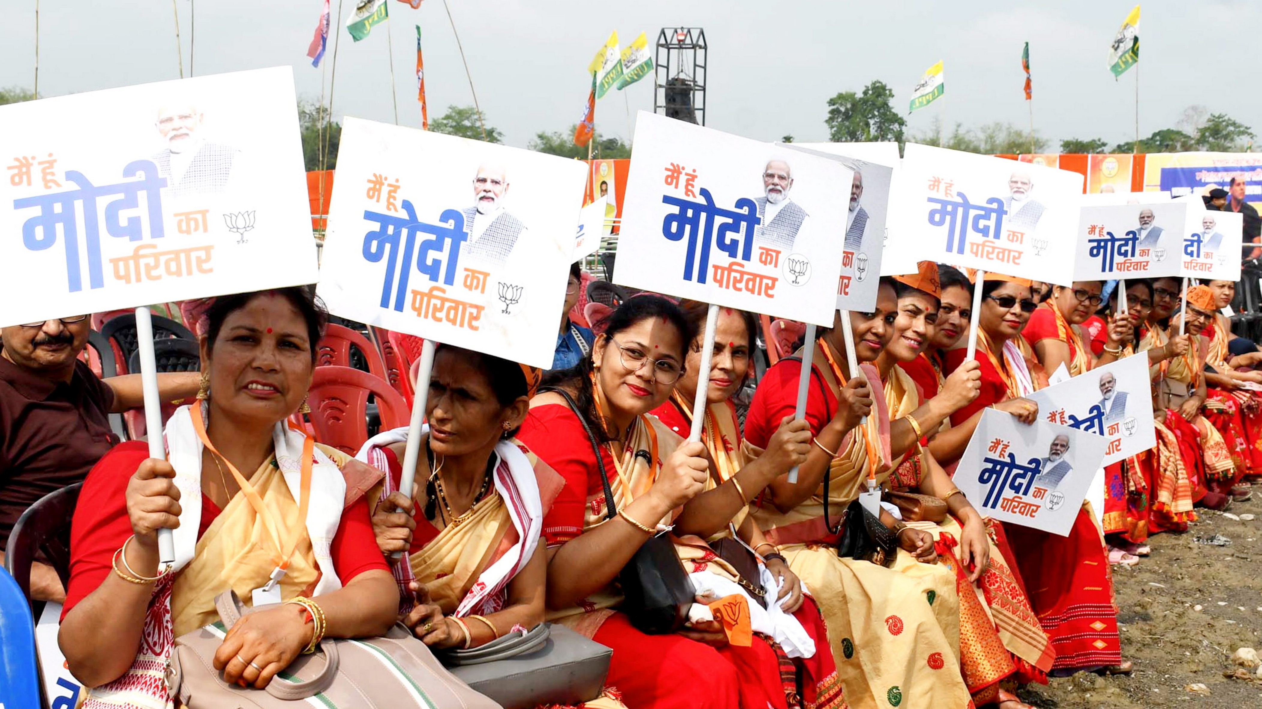 BJP supporters hold placards during a public meeting to be addressed by Prime Minister Narendra Modi in Nalbari district, Assam.