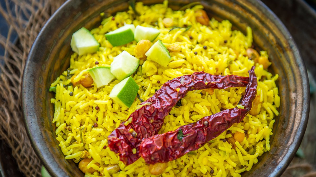 Mavinakayi Chitranna: As Ugadi coincides with the onset of the mango season, no celebration is complete without indulging in dishes featuring this king of fruits. Mavinakayi Chitranna (Mango rice) is a tangy and spicy rice preparation made with cooked rice, raw mango, and a tempering of mustard seeds, curry leaves, and peanuts.