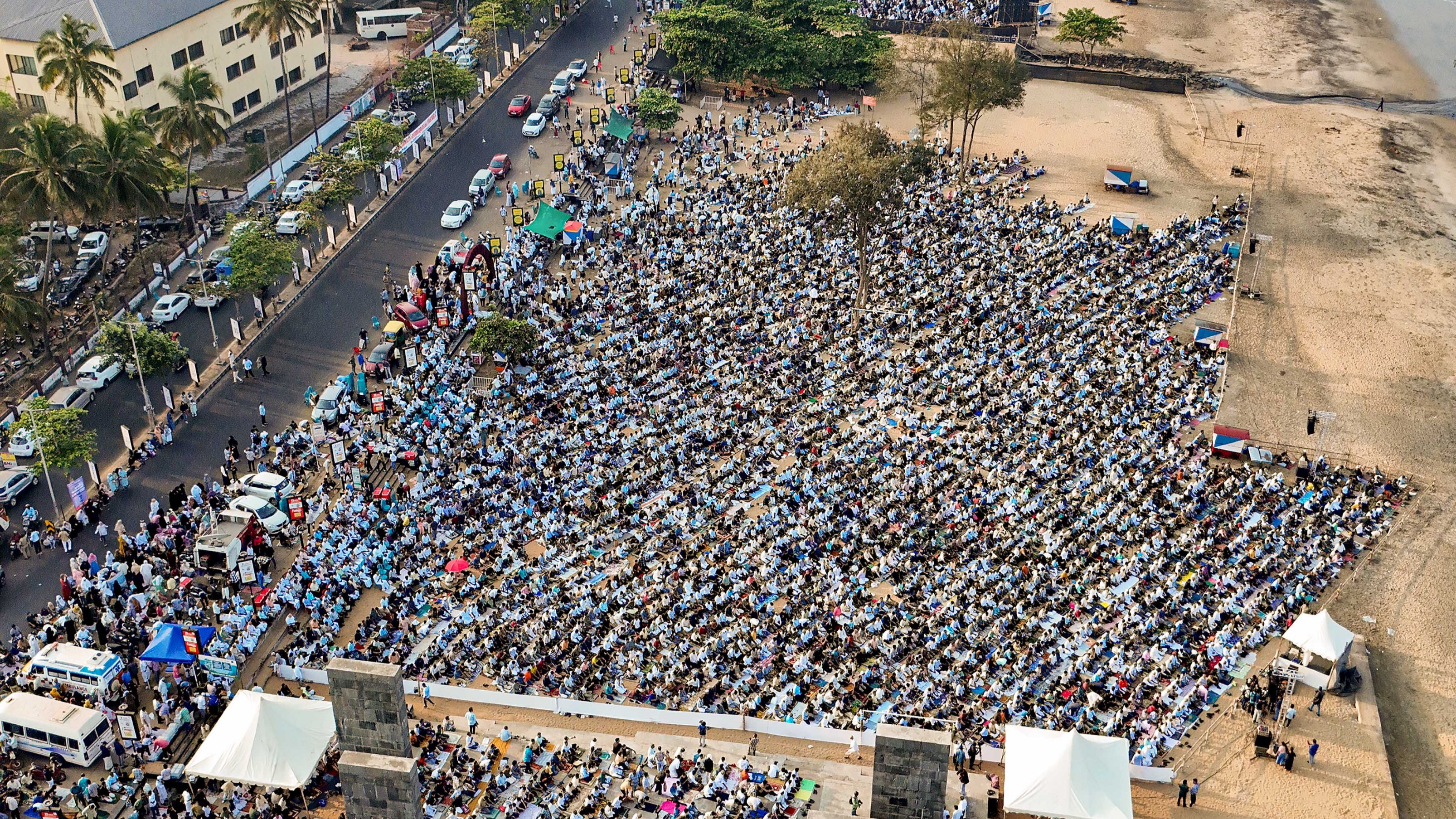 Muslim devotees offer namaz during Eid-al-Fitr celebrations, at a beach, in Kozhikode.