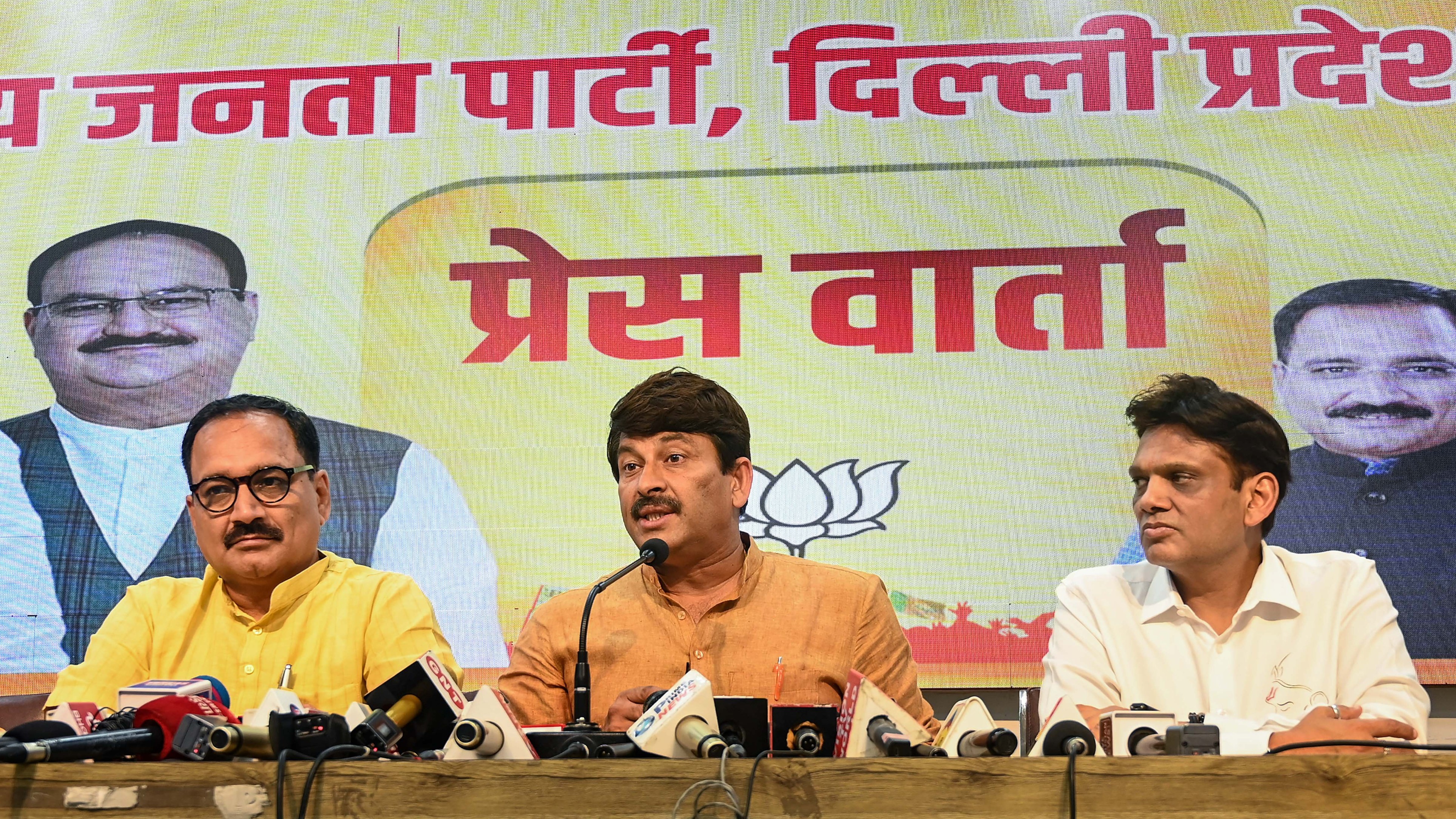 Delhi BJP President Virendra Sachdeva and party candidate Manoj Tiwari address a press conference. 