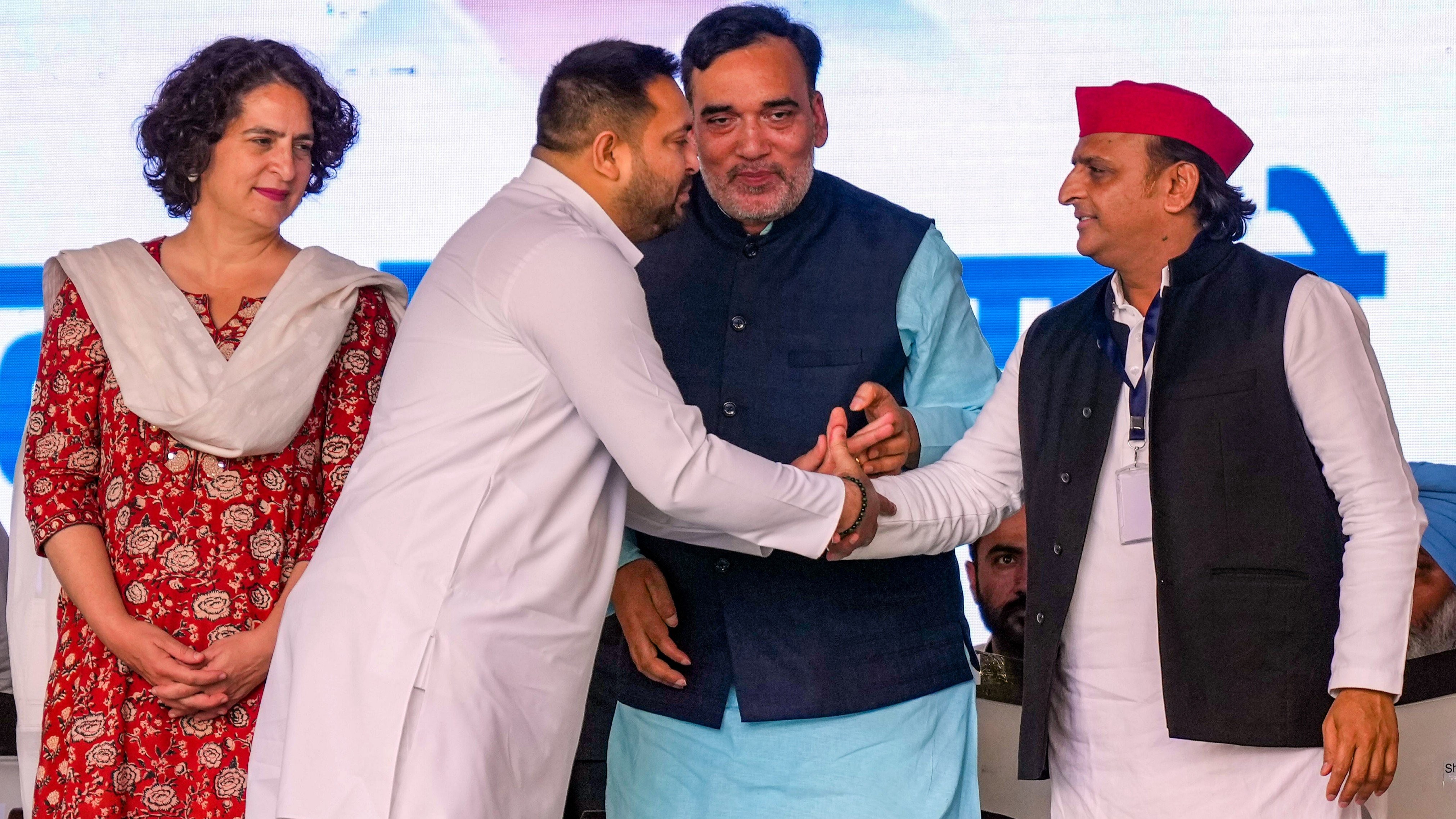 RJD leader Tejashwi Yadav shakes hands with SP chief Akhilesh Yadav as AAP leader Gopal Rai and Congress leader Priyanka Gandhi Vadra look on during I.N.D.I.A. bloc's 'Loktantra Bachao Rally' at Ramlila Maidan, in New Delhi.