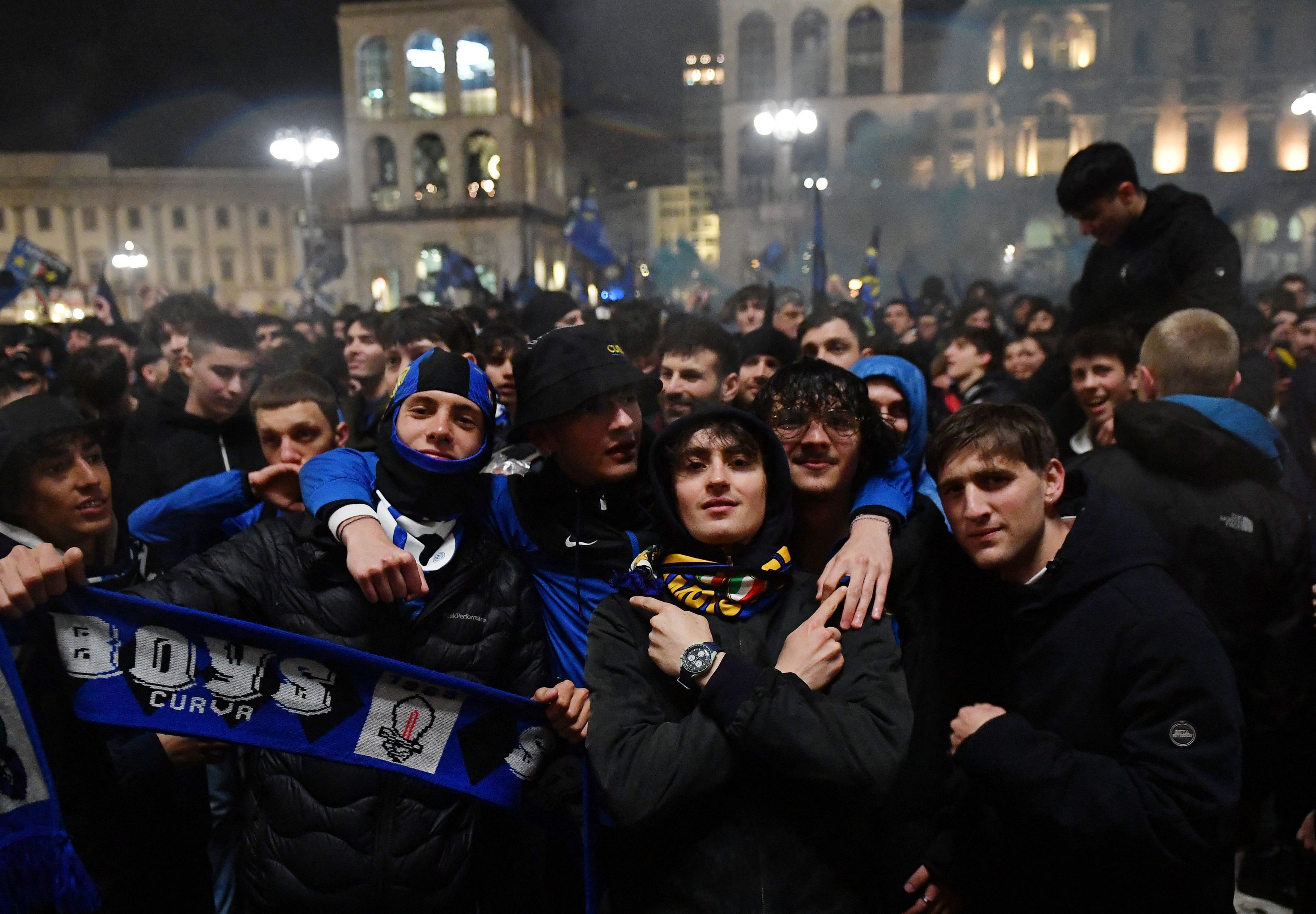 Inter Milan fans pose for a photo amid wild celebrations in Milan.