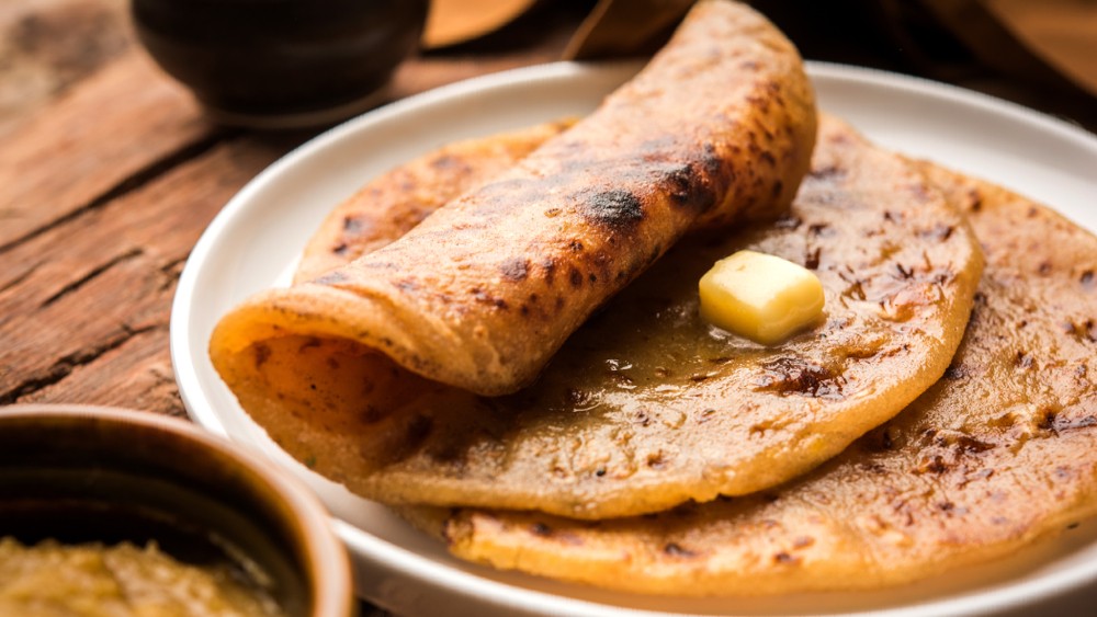 Bele Obbattu: This traditional sweet flatbread filled with a sweet lentil mixture is a staple during Ugadi festivities. The dough, made of flour, ghee, and water, is rolled out and stuffed with a flavorful mixture of cooked lentils, jaggery, and spices.
