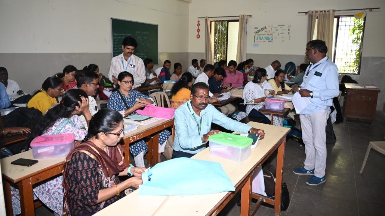 Poll officials are seen preparing to welcome voters for the polling day in the second phase of voting for the 18th Lok Sabha elections that will take place on April 26.