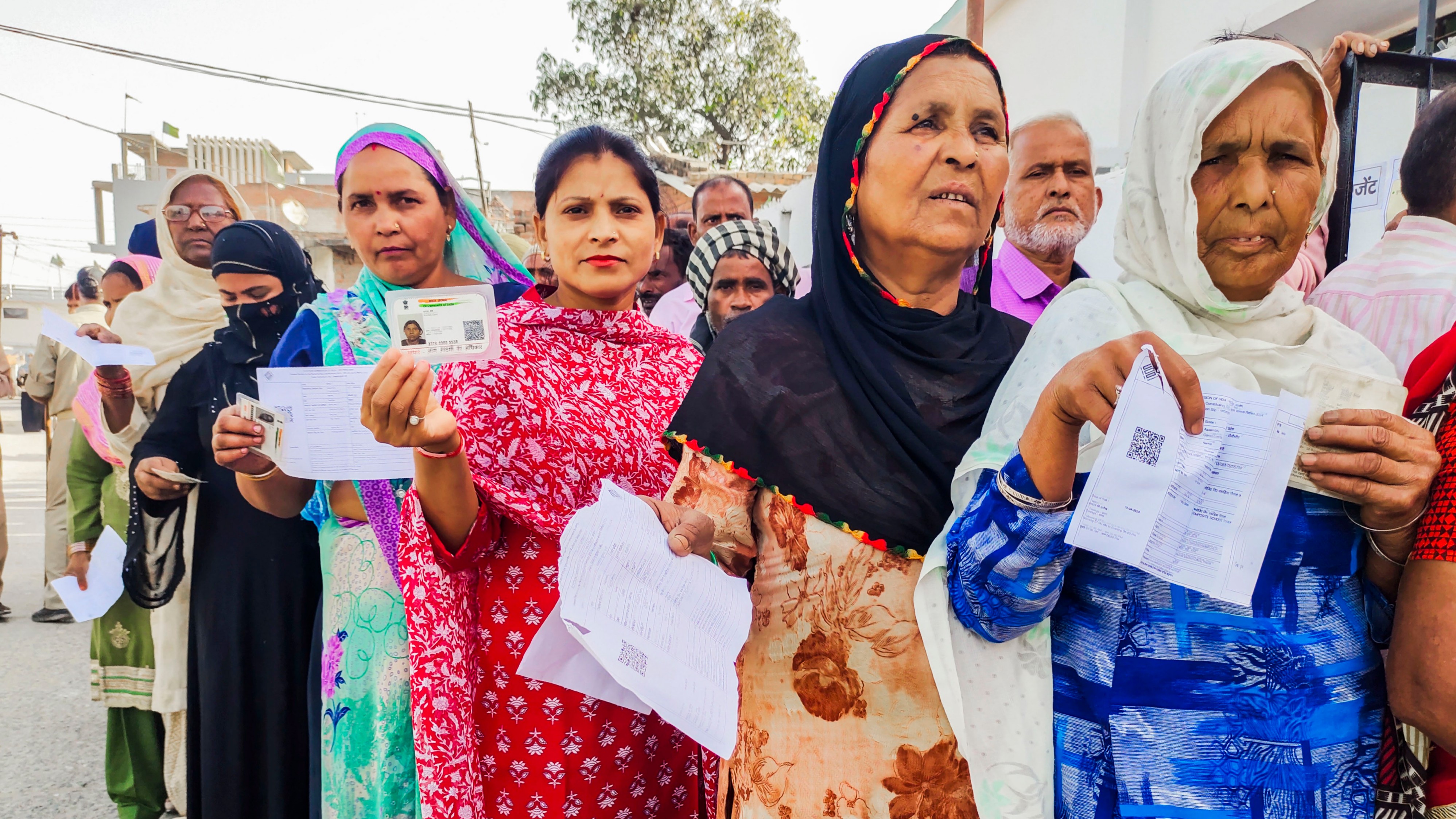 Voters wait to cast their votes for Lok Sabha elections, in Pilibhit, Uttar Pradesh.