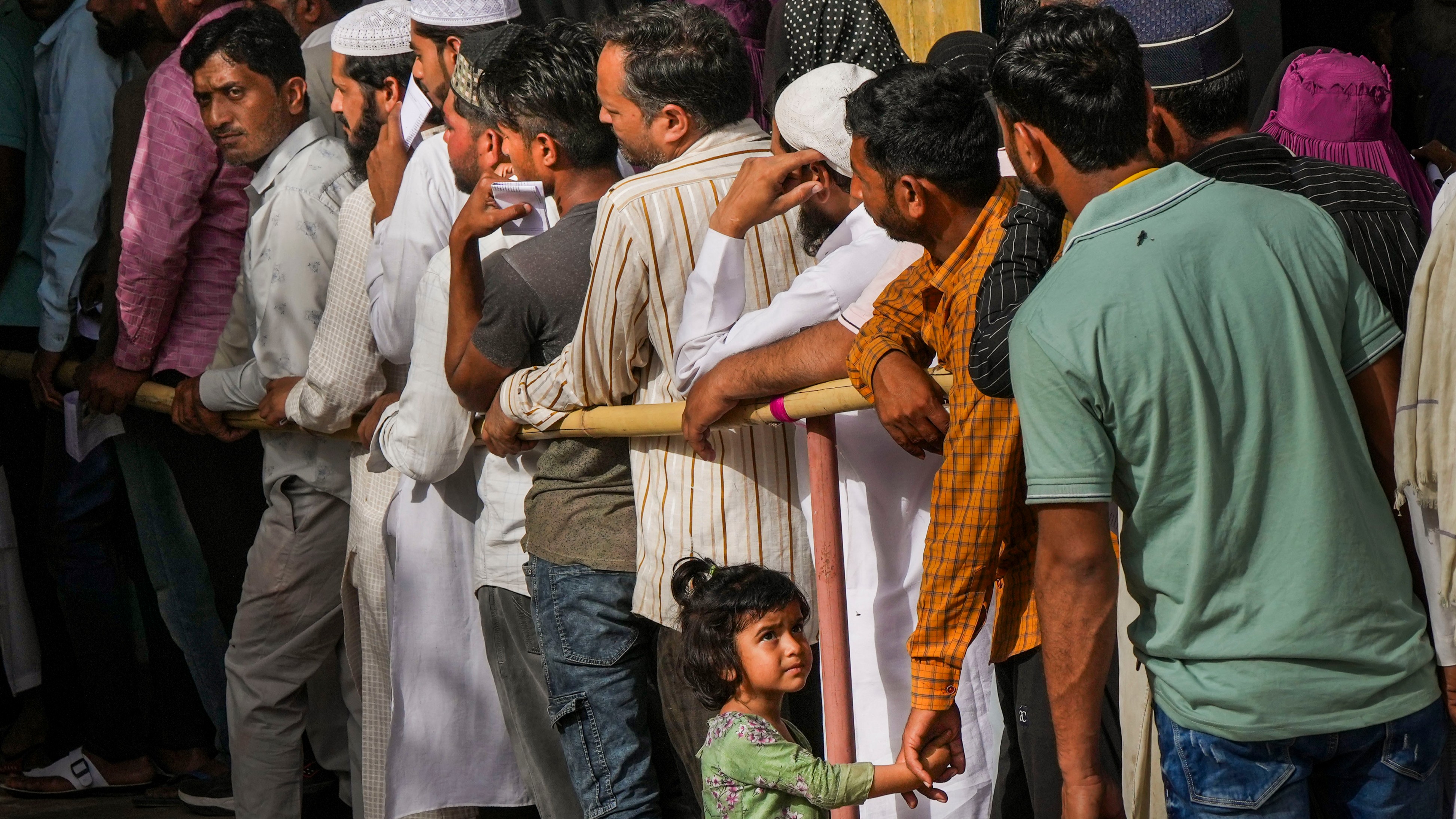 Voters wait to cast their votes for the first phase of Lok Sabha elections, in Kairana, Uttar Pradesh.