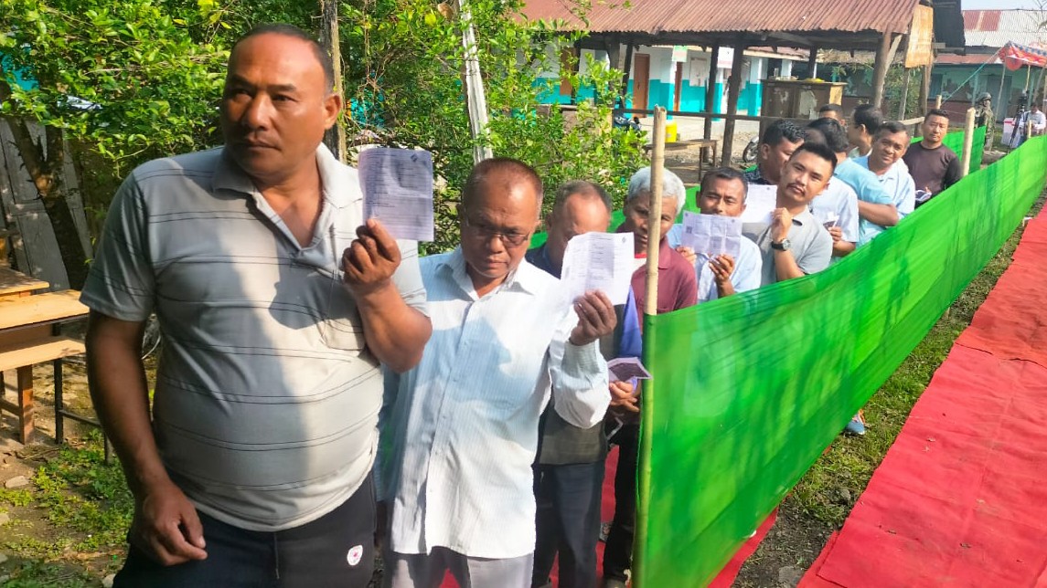 Voters wait in a queue at a polling station to cast their votes for the first phase of Lok Sabha elections, in Luwangsangbam, Manipur.