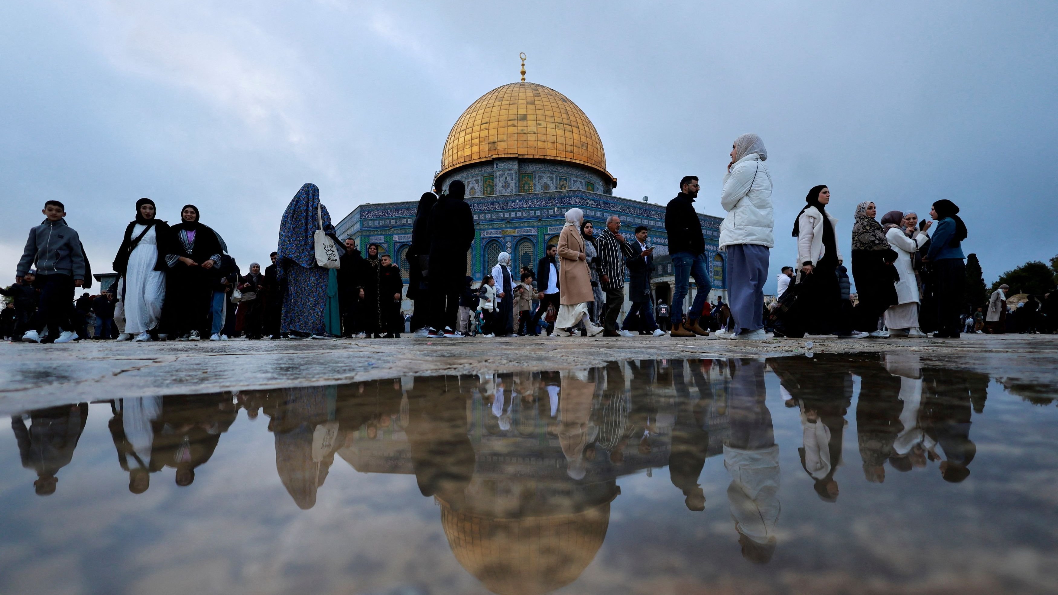 Muslims walk at Al-Aqsa compound on Eid al-Fitr in Jerusalem's Old City.