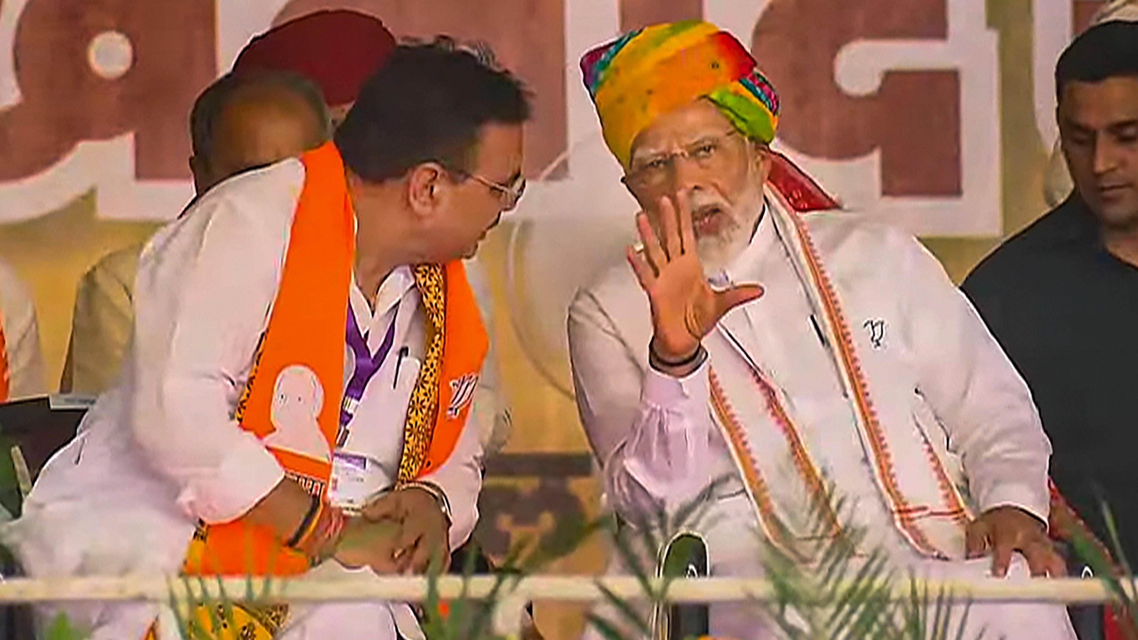 Prime Minister Narendra Modi is seen talking to Rajasthan Chief Minister Bhajanlal Sharma during a rally in Rajasthan.