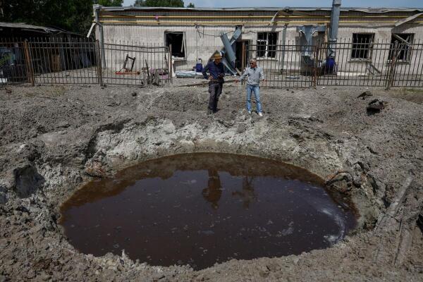 Sergii Polituchyi, Ukrainian publisher and businessman, shows Reuters journalist one of craters next to his printing house, which appeared after a recent Russian missile strike, amid Russia's attack on Ukraine, in Kharkiv, Ukraine May 26, 2024.