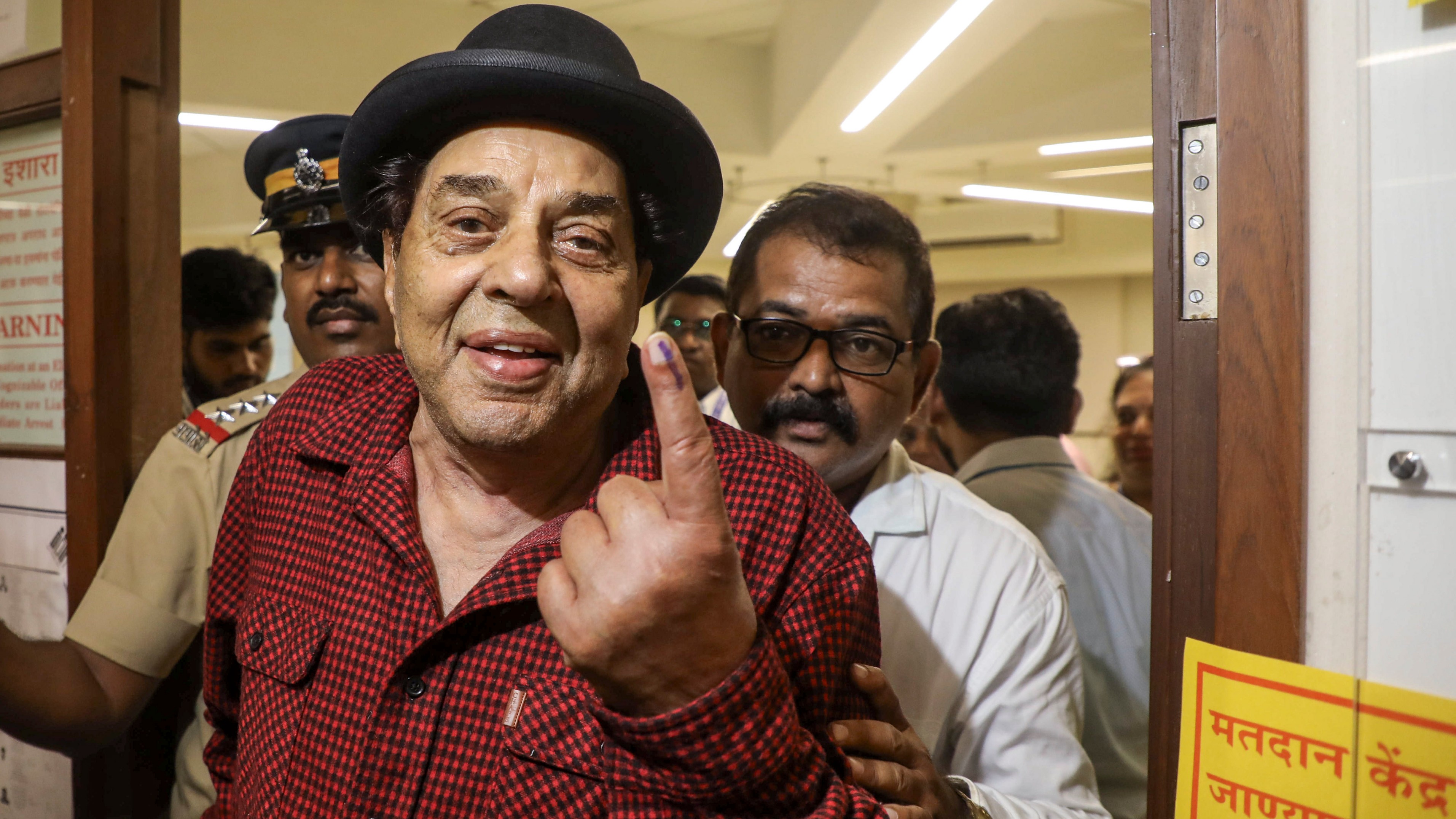 Legendary actor Dharmendra shows his inked finger after casting his vote for the fifth phase of Lok Sabha elections, in Mumbai.
