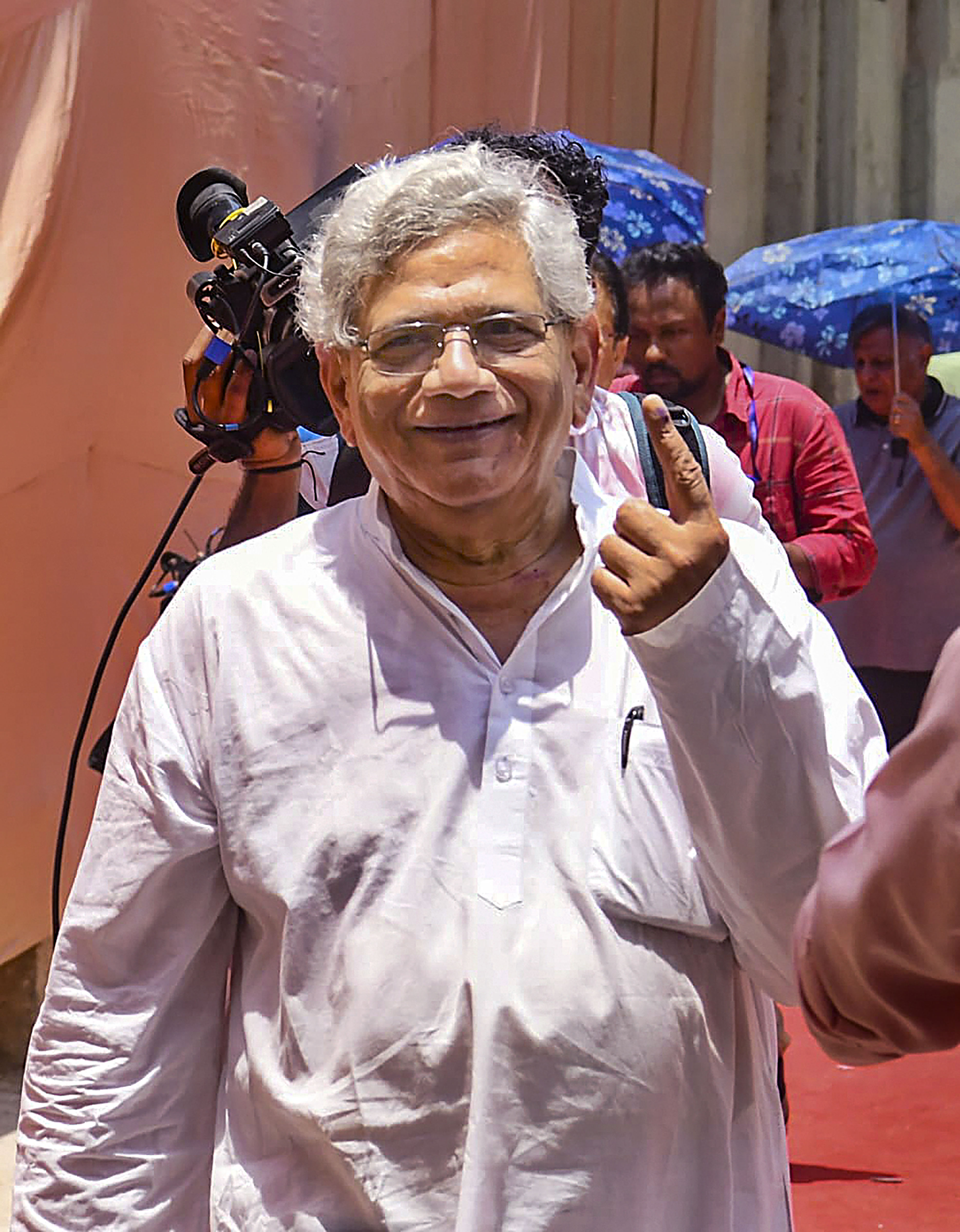 CPI(M) General Secretary Sitaram Yechury flashes his ink-marked finger after casting his vote for the 6th phase of Lok Sabha elections, in New Delhi, on Saturday.