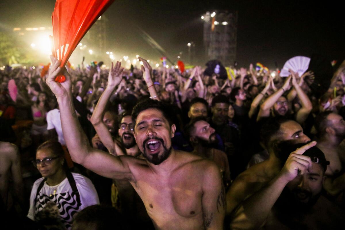 People gather at Copacabana beach to attend Madonna's free concert in Rio de Janeiro.