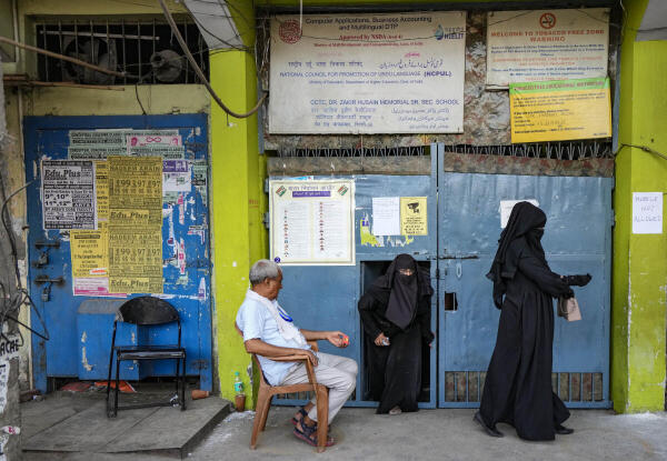 Women come out of a polling station during the sixth phase of Lok Sabha elections, Zafrabad, in New Delhi on Saturday. 